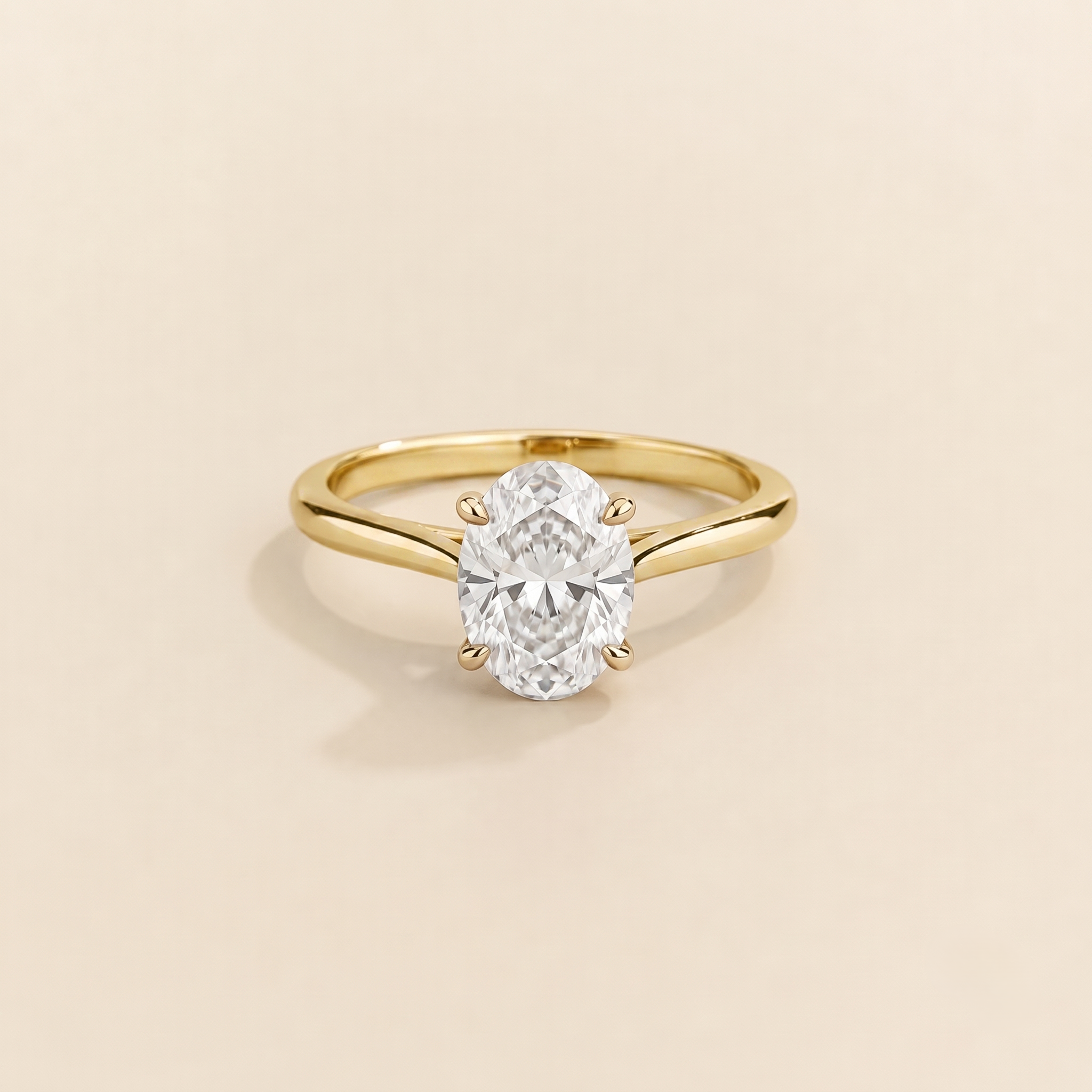 Juvetti yellow gold ring featuring a oval-cut lab-grown diamond in an east–west setting.