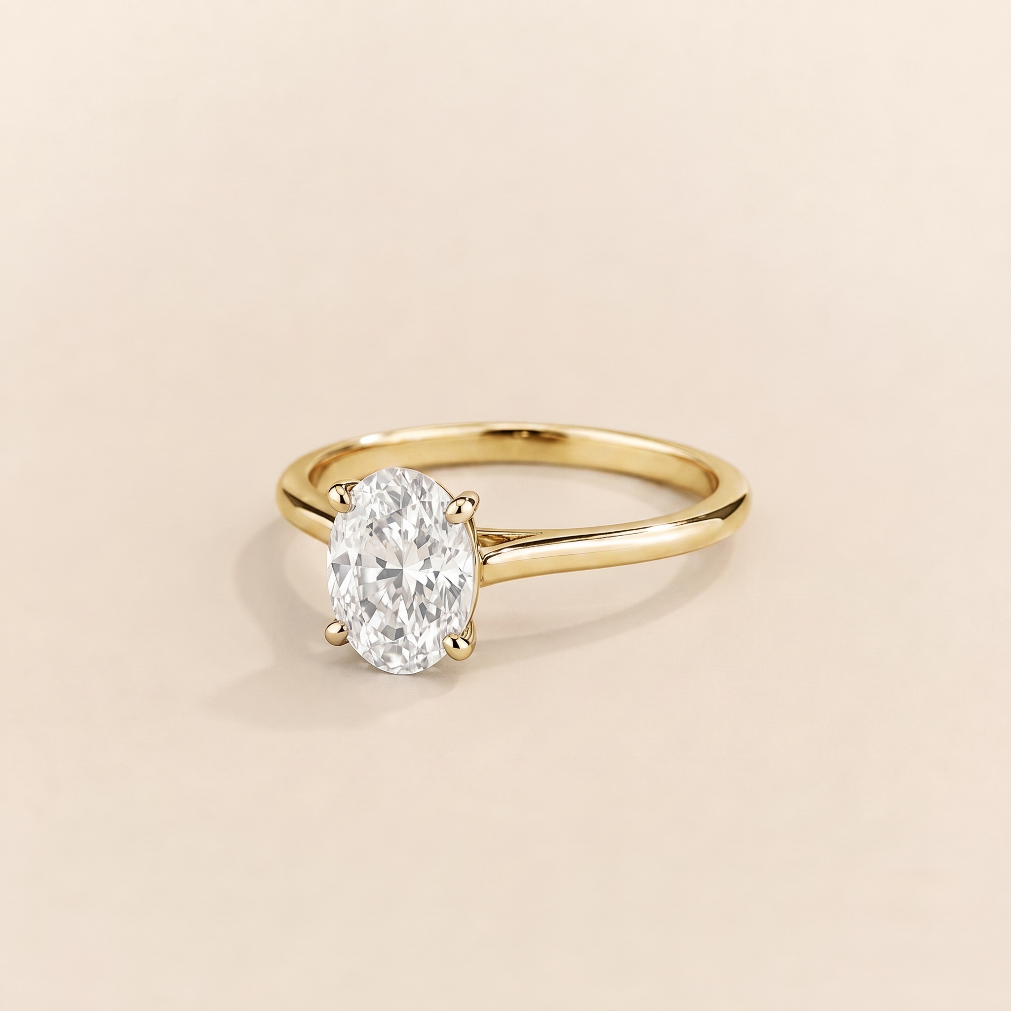 Juvetti yellow gold ring featuring a oval-cut lab-grown diamond in an east–west setting.
