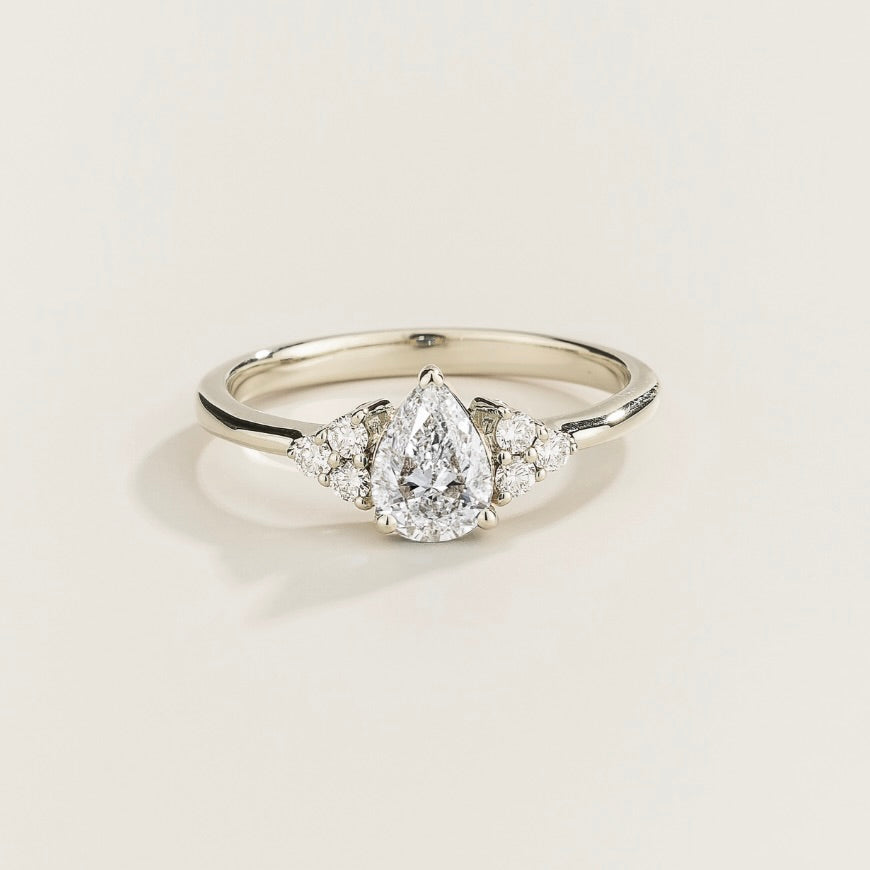 Juvetti white gold ring featuring a pear-cut lab-grown diamond with lab-grown diamond side stones.