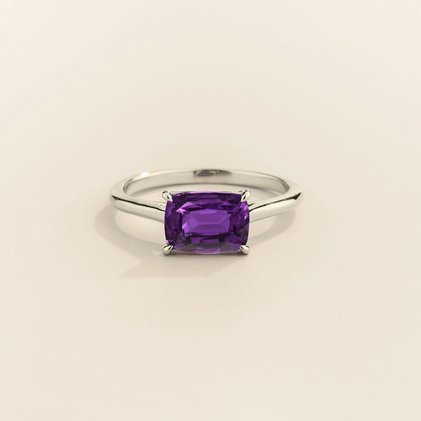 Kissen Ring in white gold, set with a Purple Sapphire in an east–west setting.