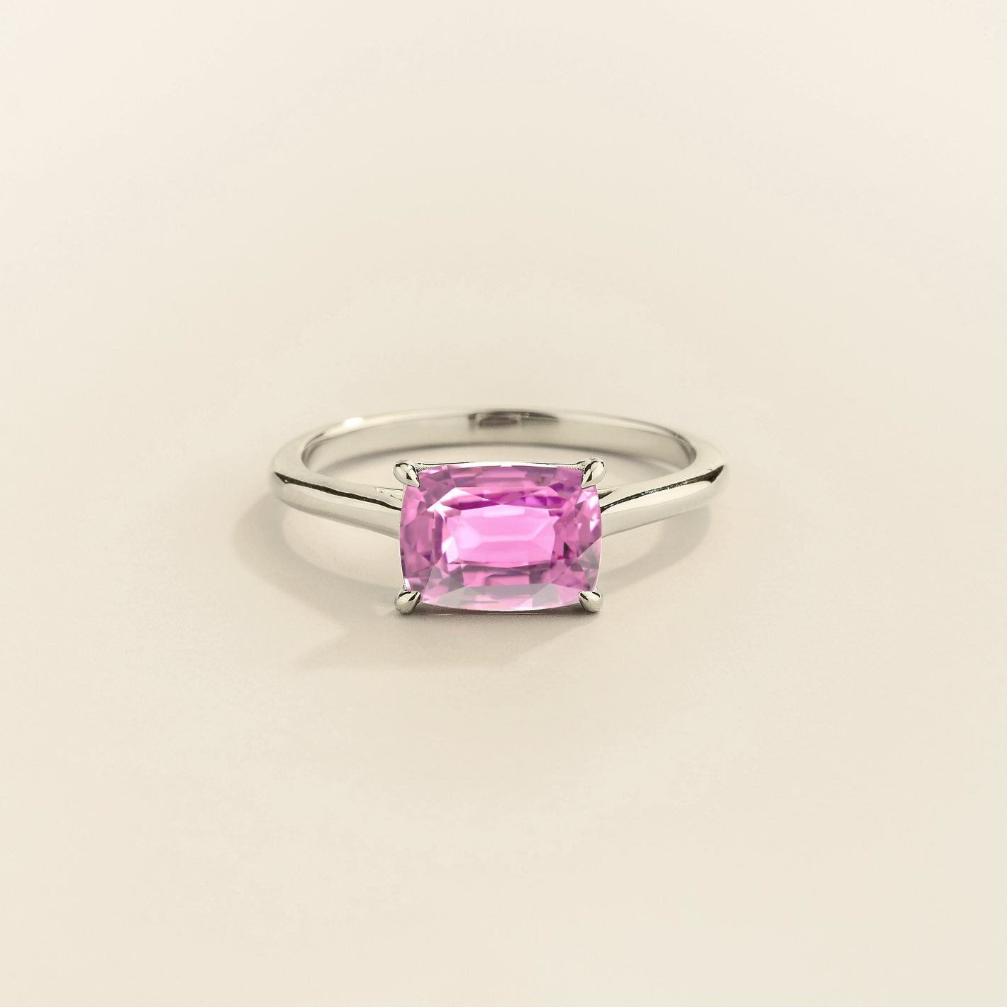 Kissen Ring in white gold, set with a Pink Sapphire in an east–west setting.