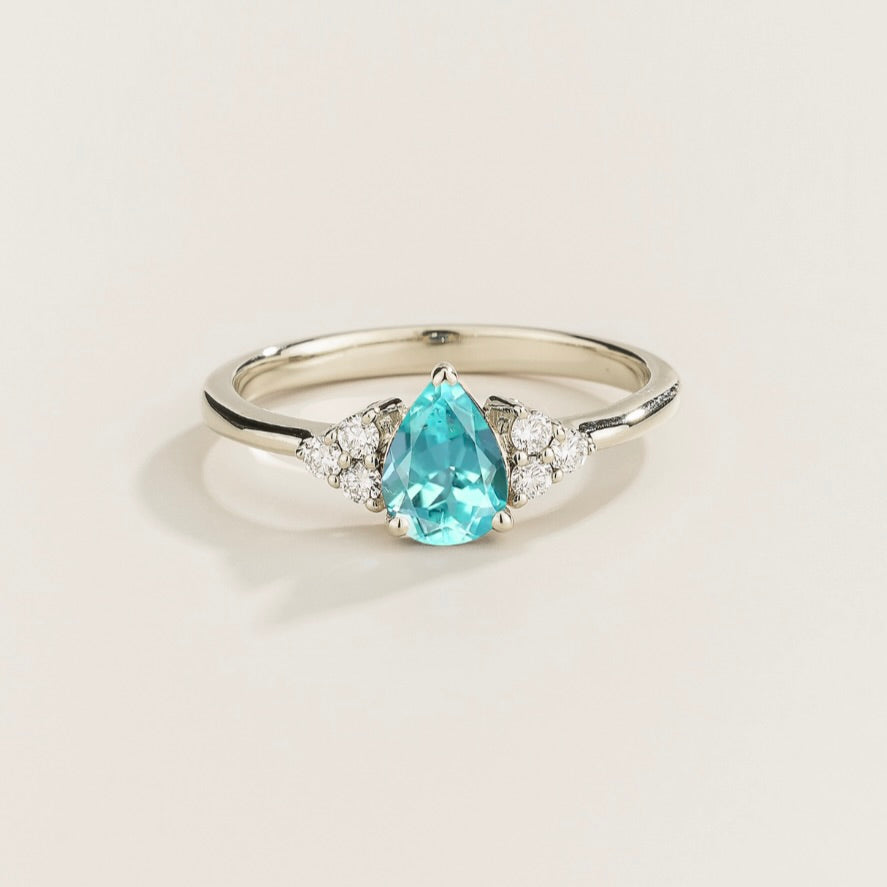 Juvetti white gold ring featuring a pear-cut lab-grown paraiba gemstone with lab-grown diamond side stones.
