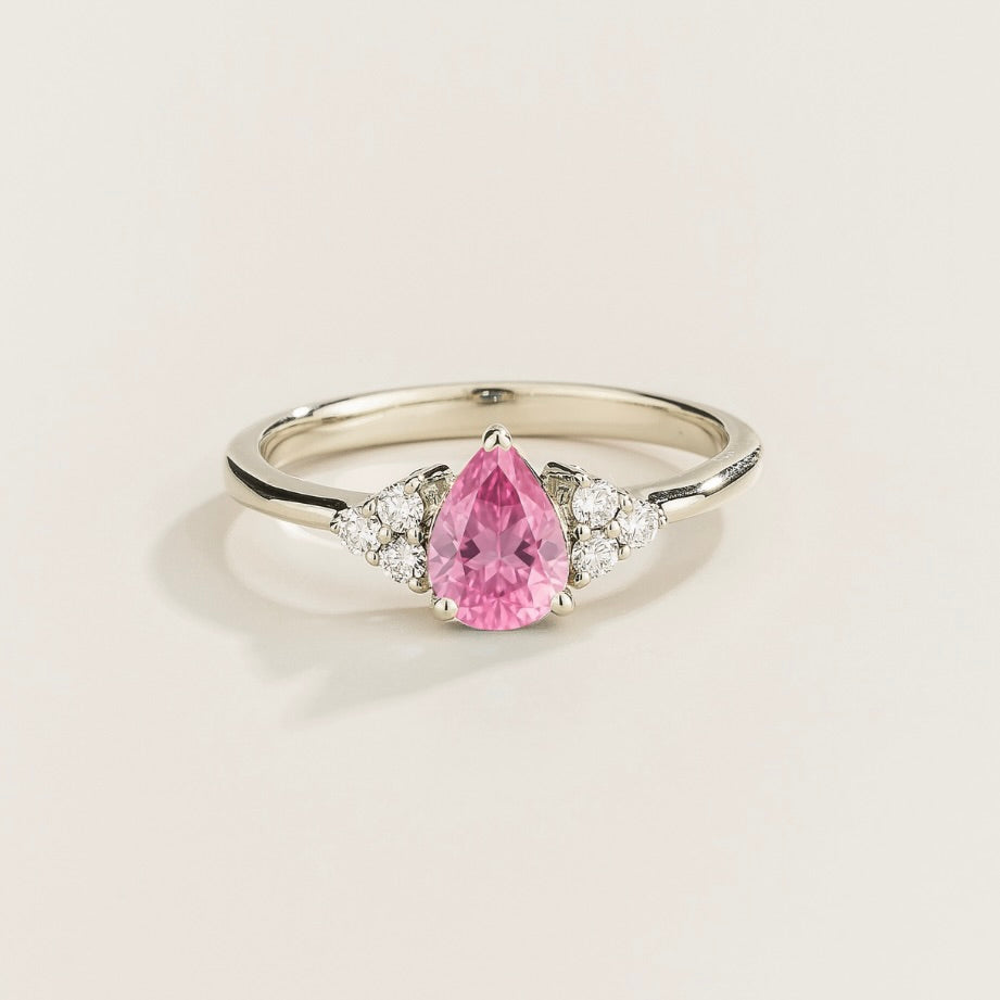 Juvetti white gold ring featuring a pear-cut lab-grown pink sapphire with lab-grown diamond side stones.