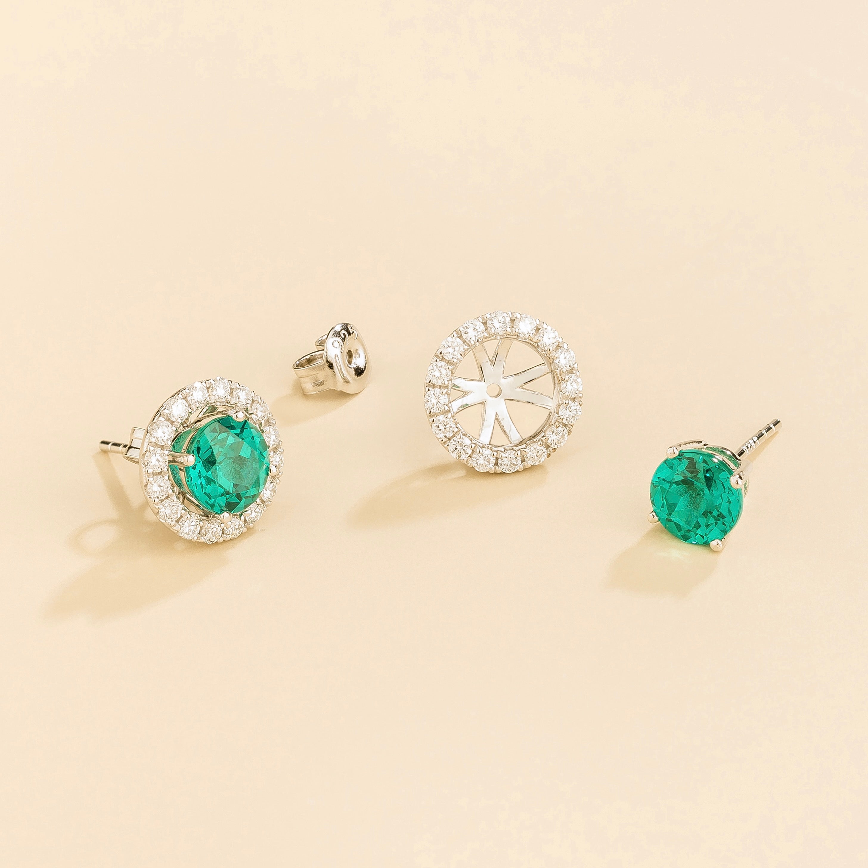 A pair of white gold floret earrings set with round paraiba sapphire centerpiece and surrounding round diamonds halo. Removable halo piece. ā Juvetti London