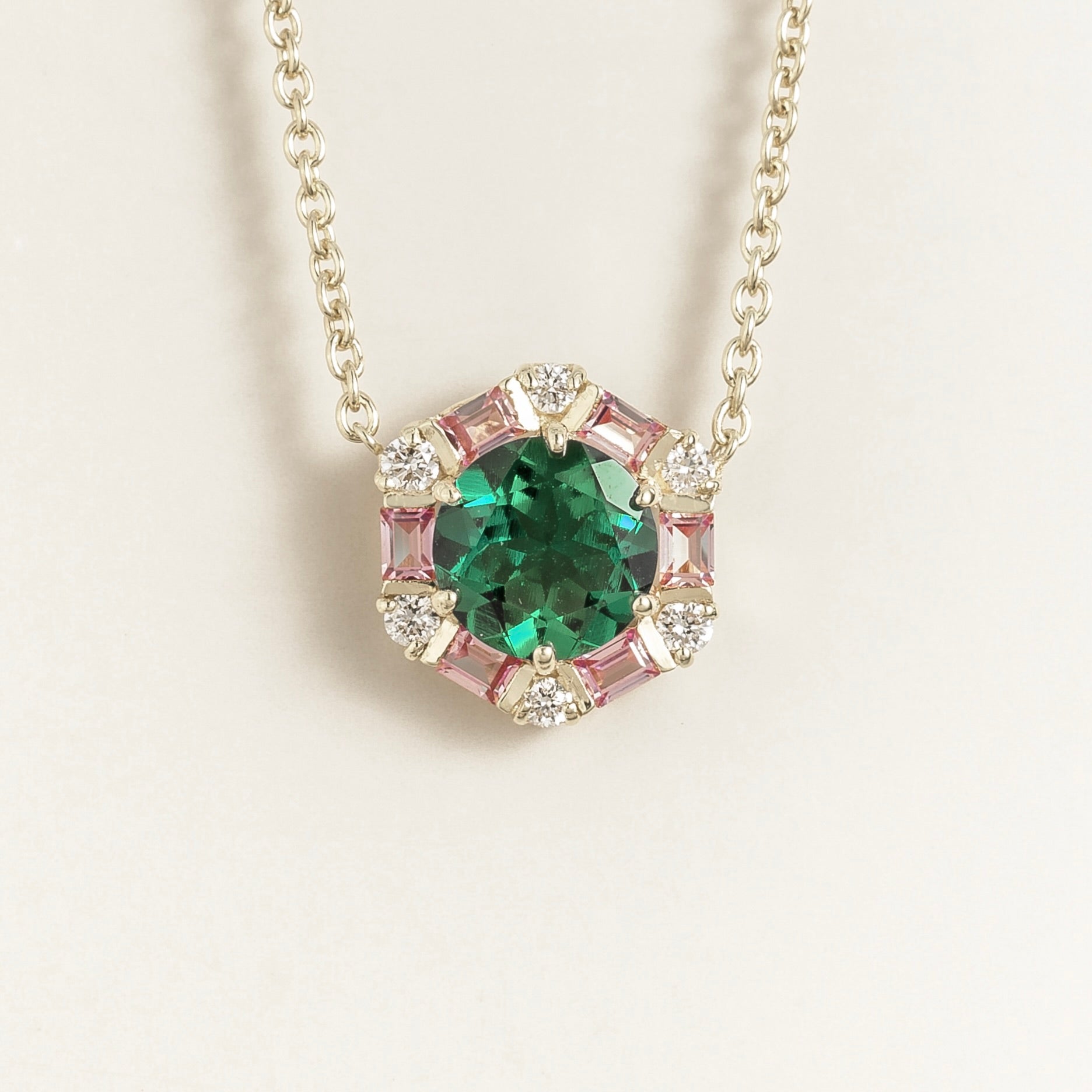 Hexagon halo lab-grown emerald, pink sapphire and diamond pendant necklace, Melba design in white gold | Juvetti London