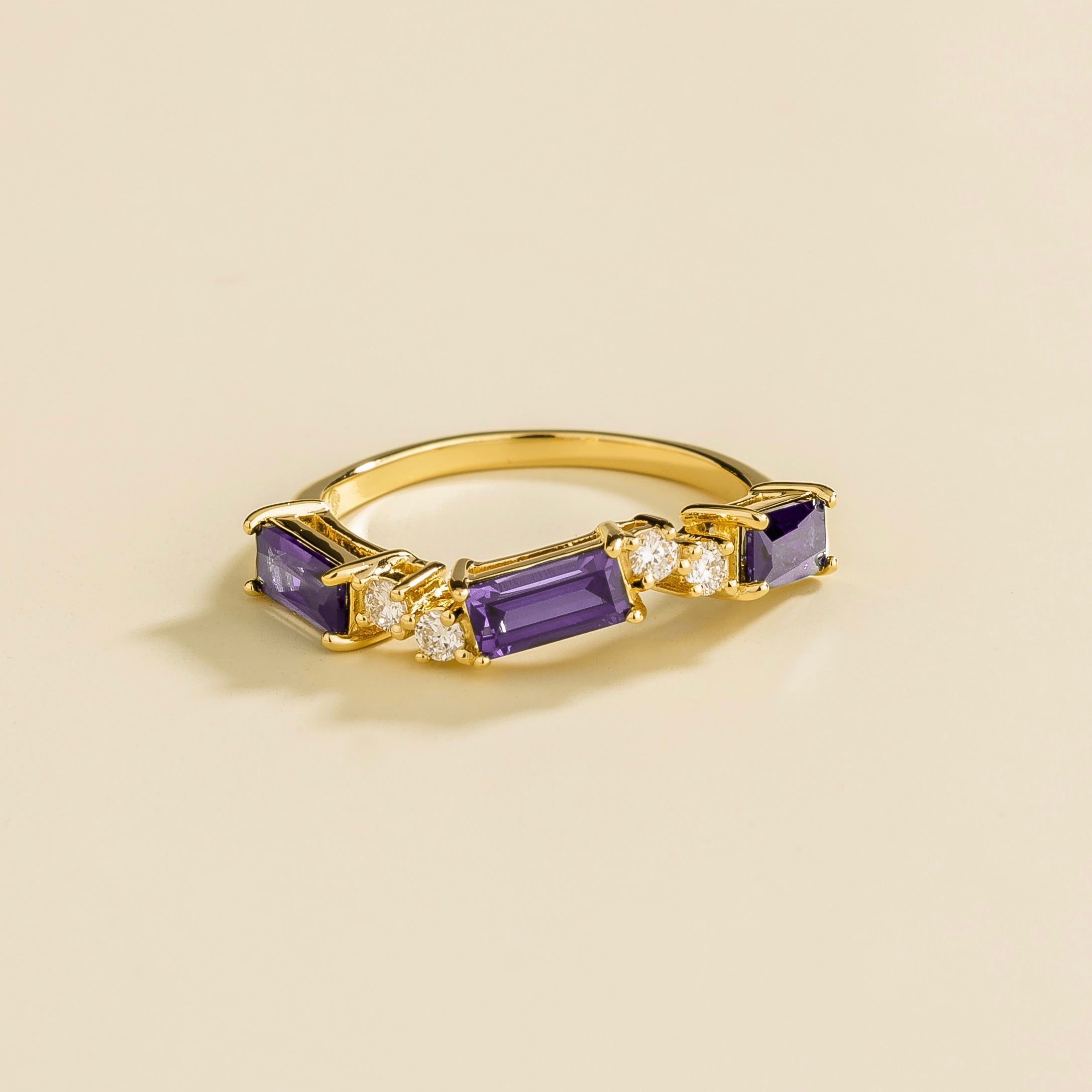 Juvetti gold ring showcasing ethical lab-grown baguette-cut purple sapphires and round brilliant diamonds.