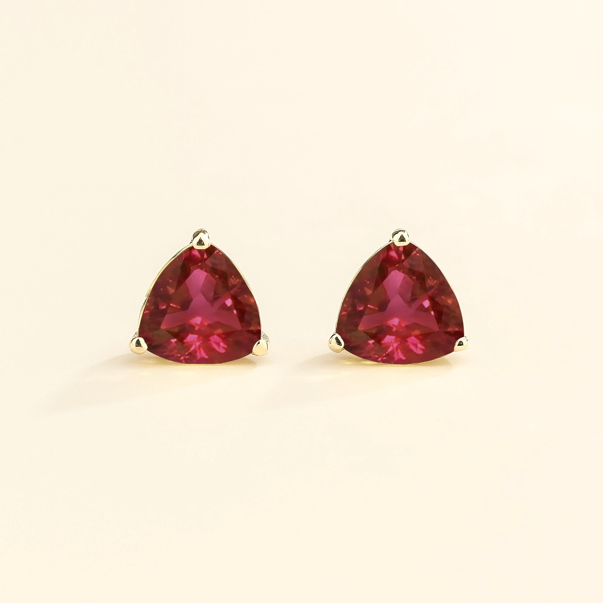 Trillion-cut lab-grown ruby solitaire stud earrings in white gold | Juvetti London