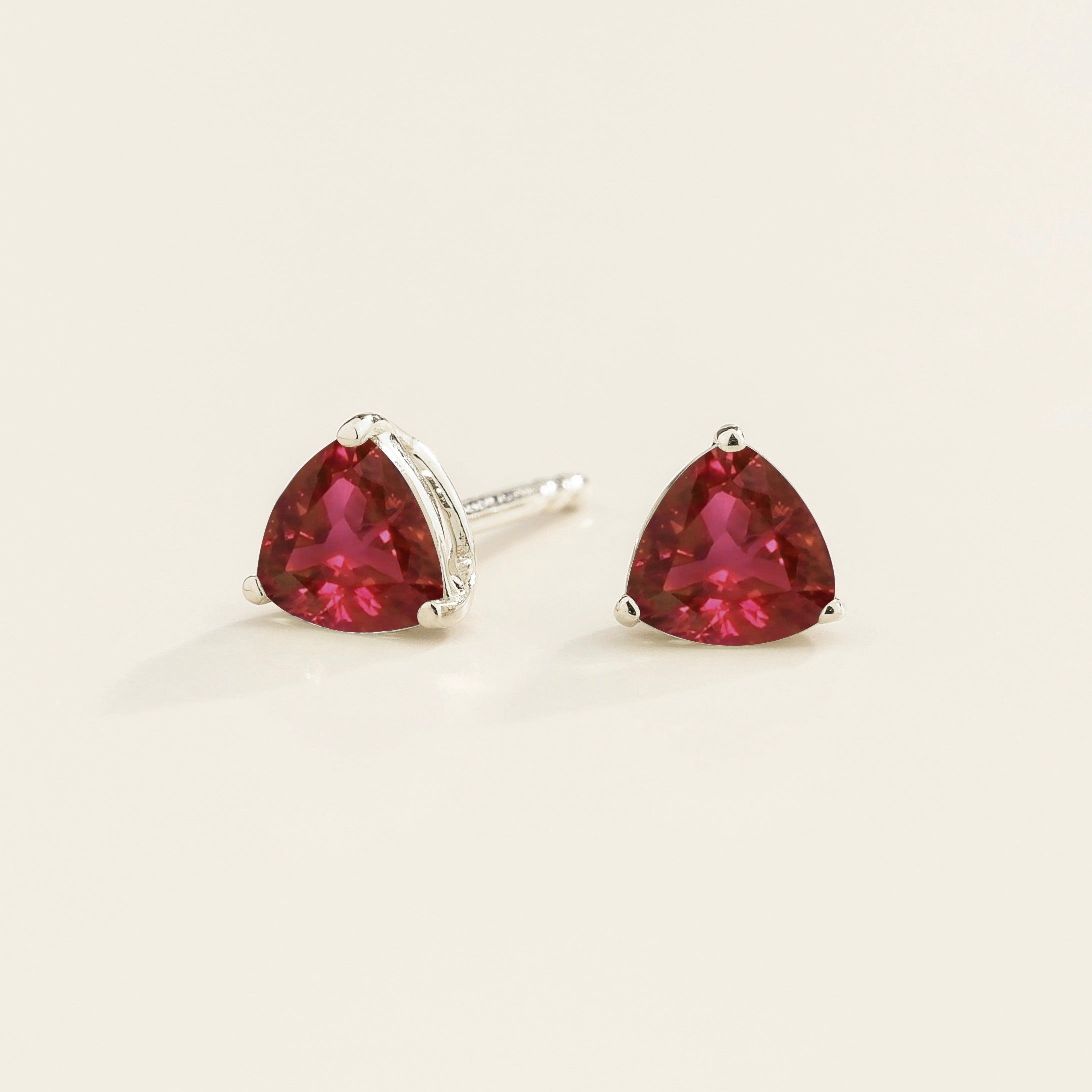 Trillion Ruby Solitaire Stud Earrings in White Gold