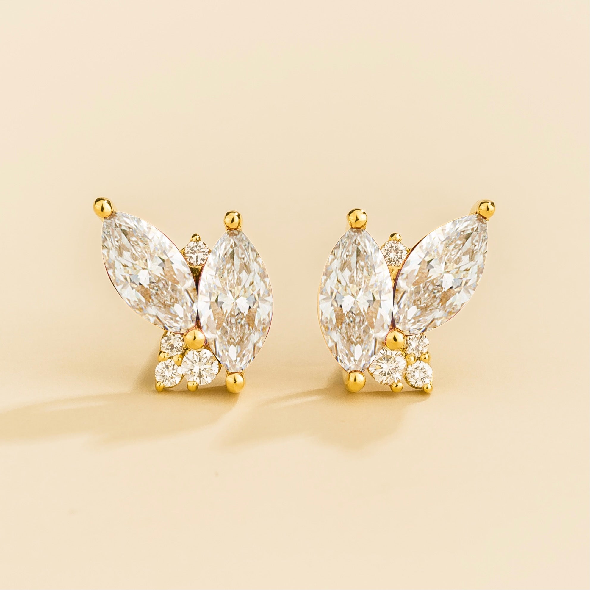 A pair of Vento gold earrings set with marquis diamonds and round diamonds.