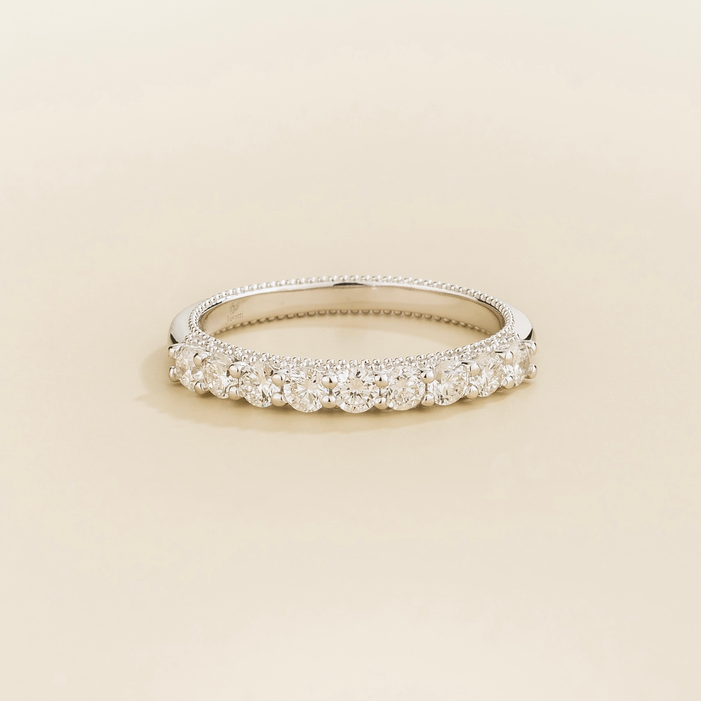 Juvetti white gold band featuring round lab-grown diamonds in a classic half-eternity design.