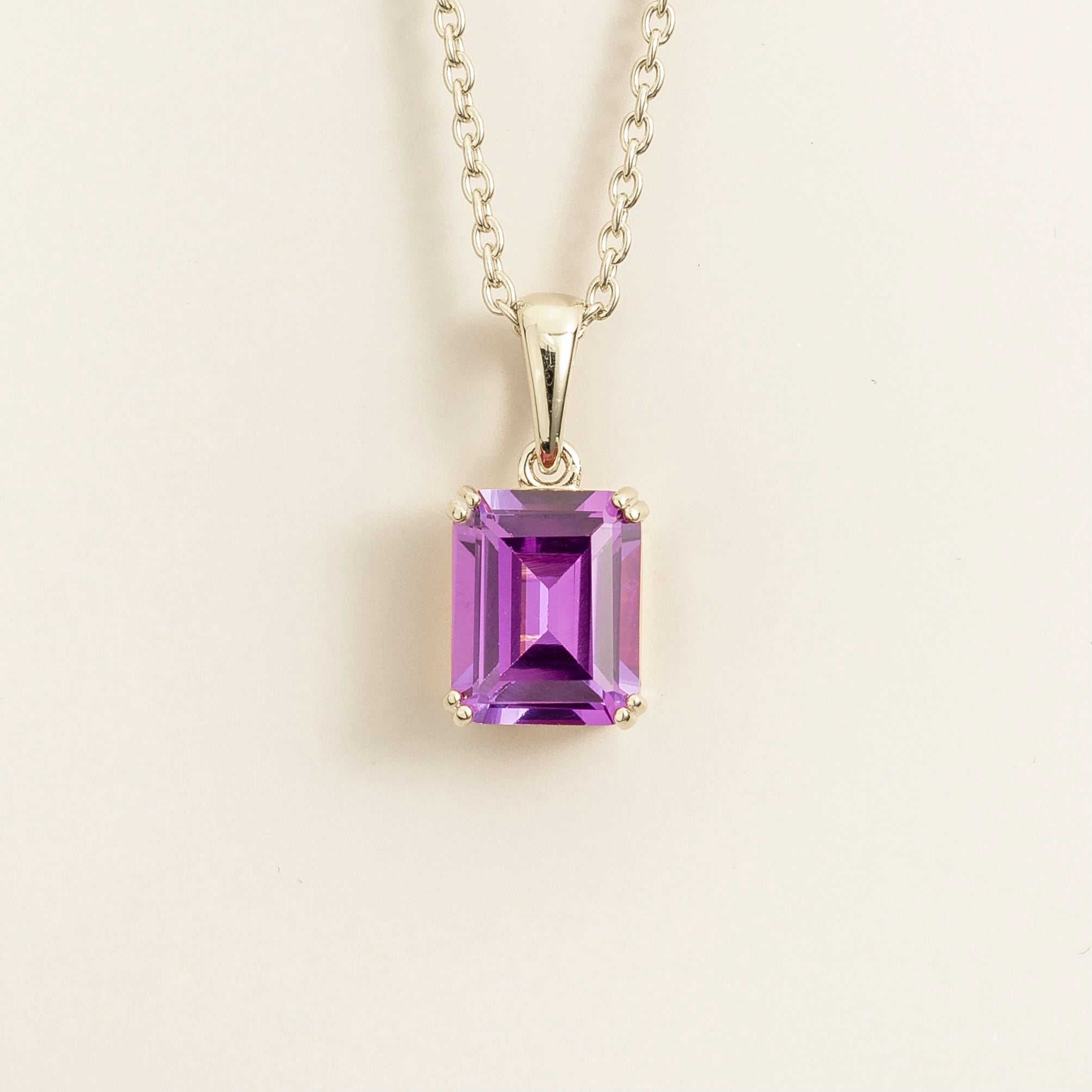 Emerald-cut purple sapphire pendant necklace in white gold with four-prong setting