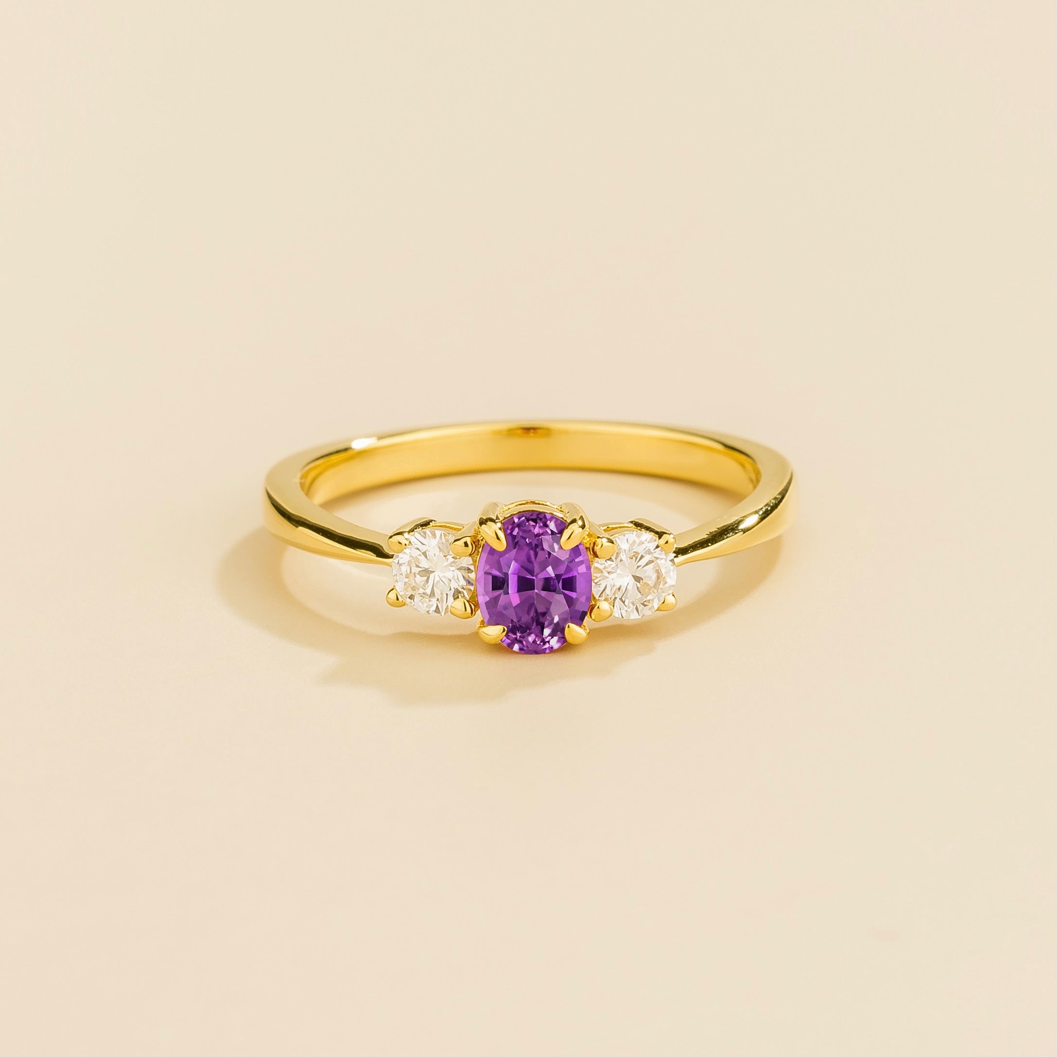 3 gemstones gold ring with a central purple sapphire flanked by two diamonds by Juvetti London
