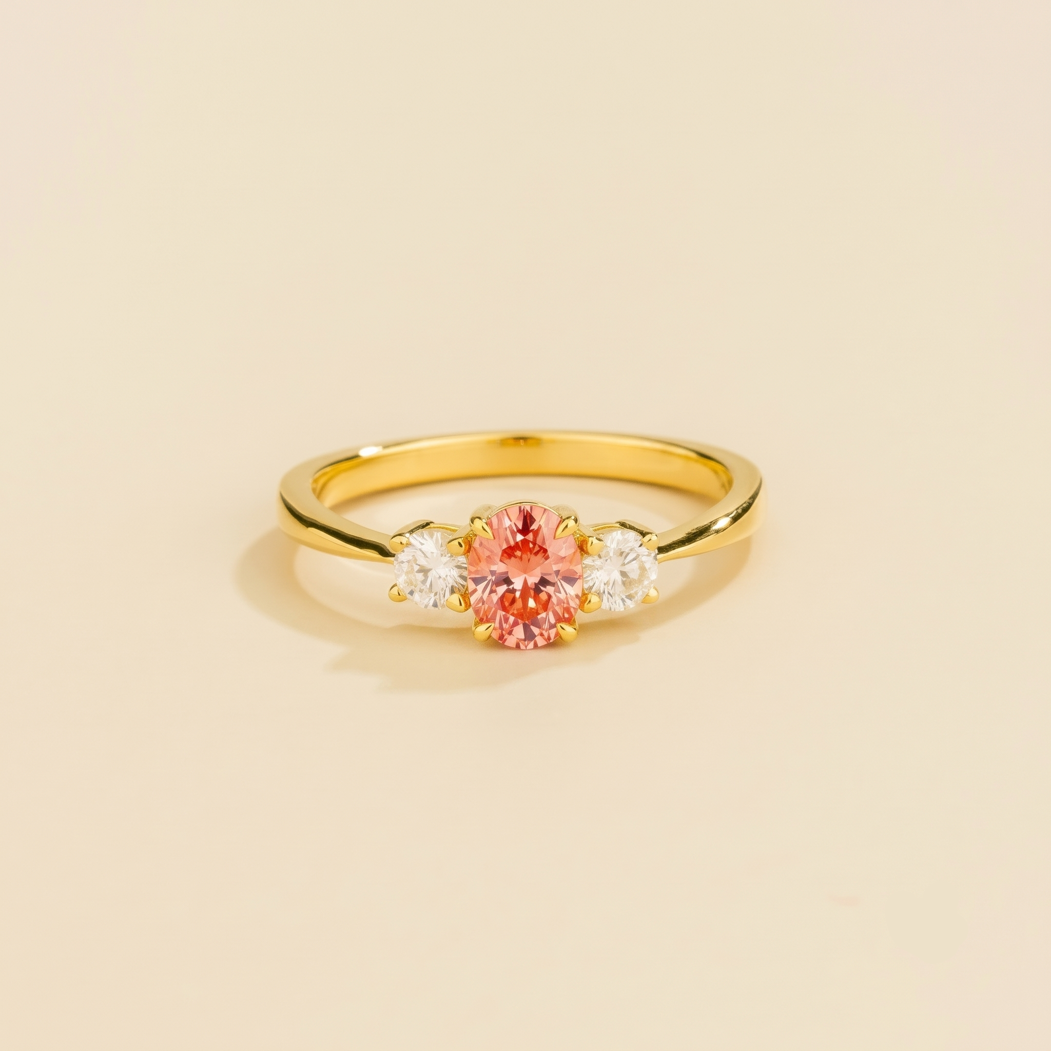 Oval lab-grown padparadscha sapphire and diamond three-stone Boble ring in gold | Juvetti London