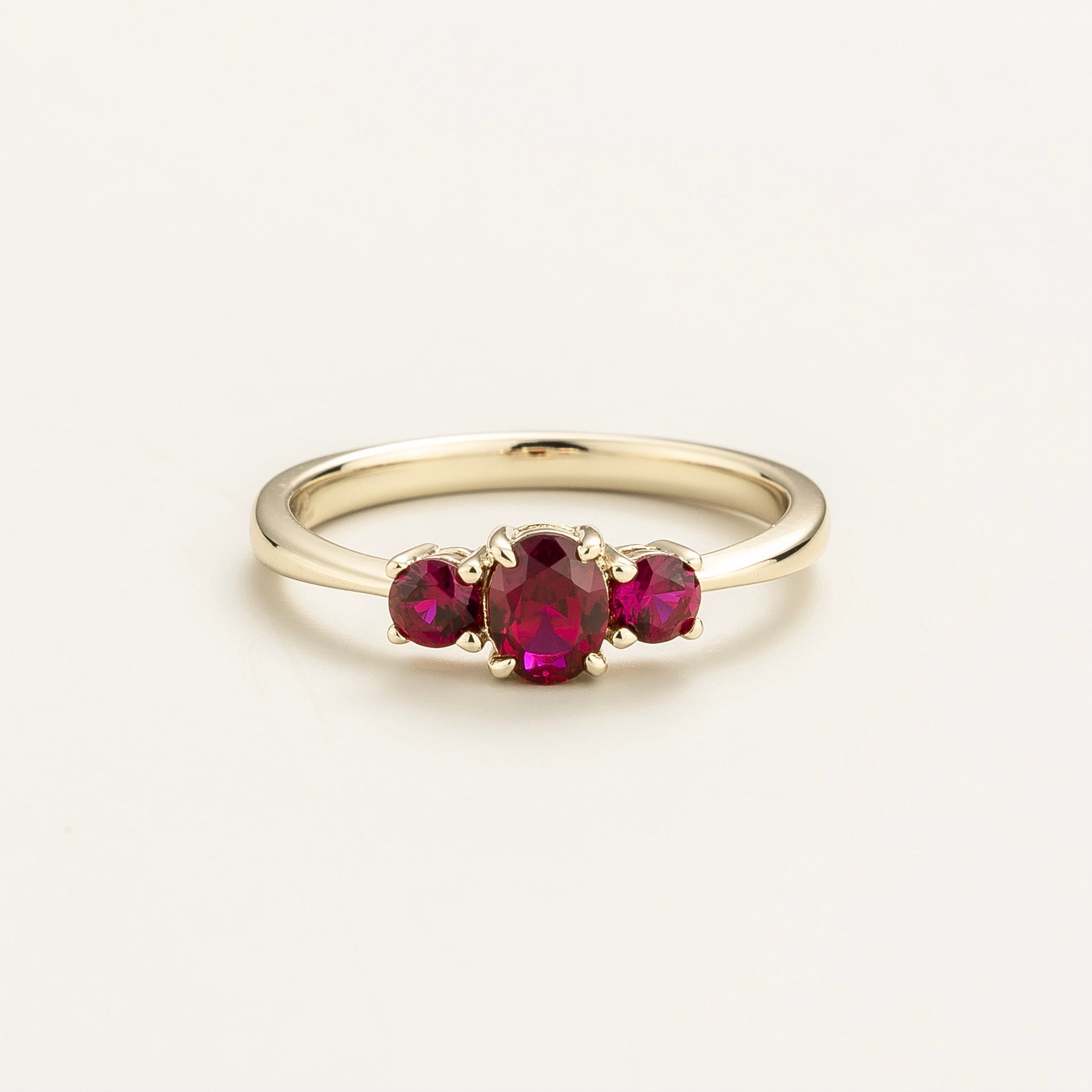 A white gold ring with three red ruby gemstones set in a crown design Ethical Fine Jewellery