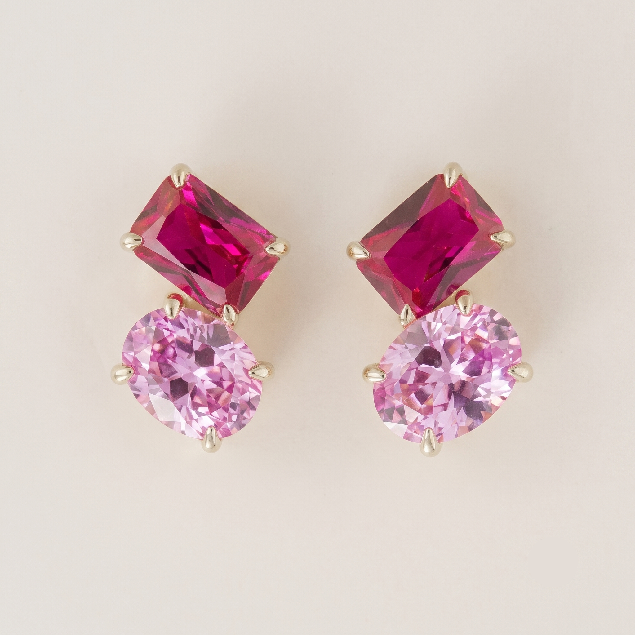 Emerald-cut and oval lab-grown pink sapphire two-stone earrings, Buchon design in white gold | Juvetti London
