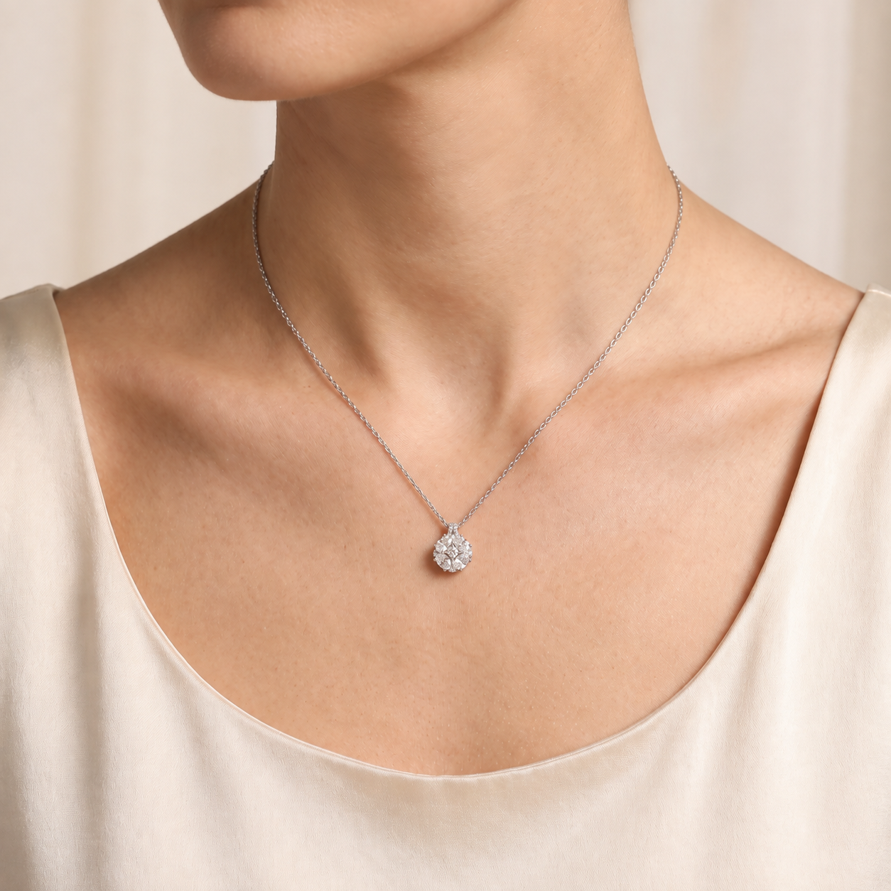A model is wearing Oval-Cut Diamond Pendant Necklace in White Gold