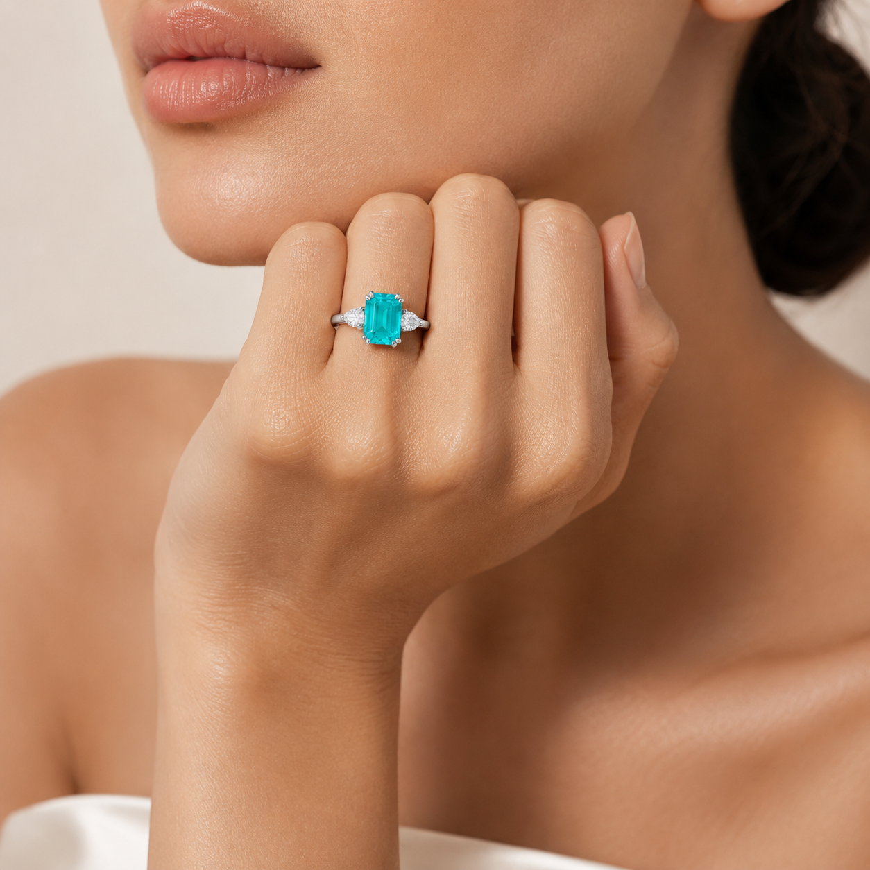 Model wearing the Ailes emerald cut ring, shown in the ruby colourway