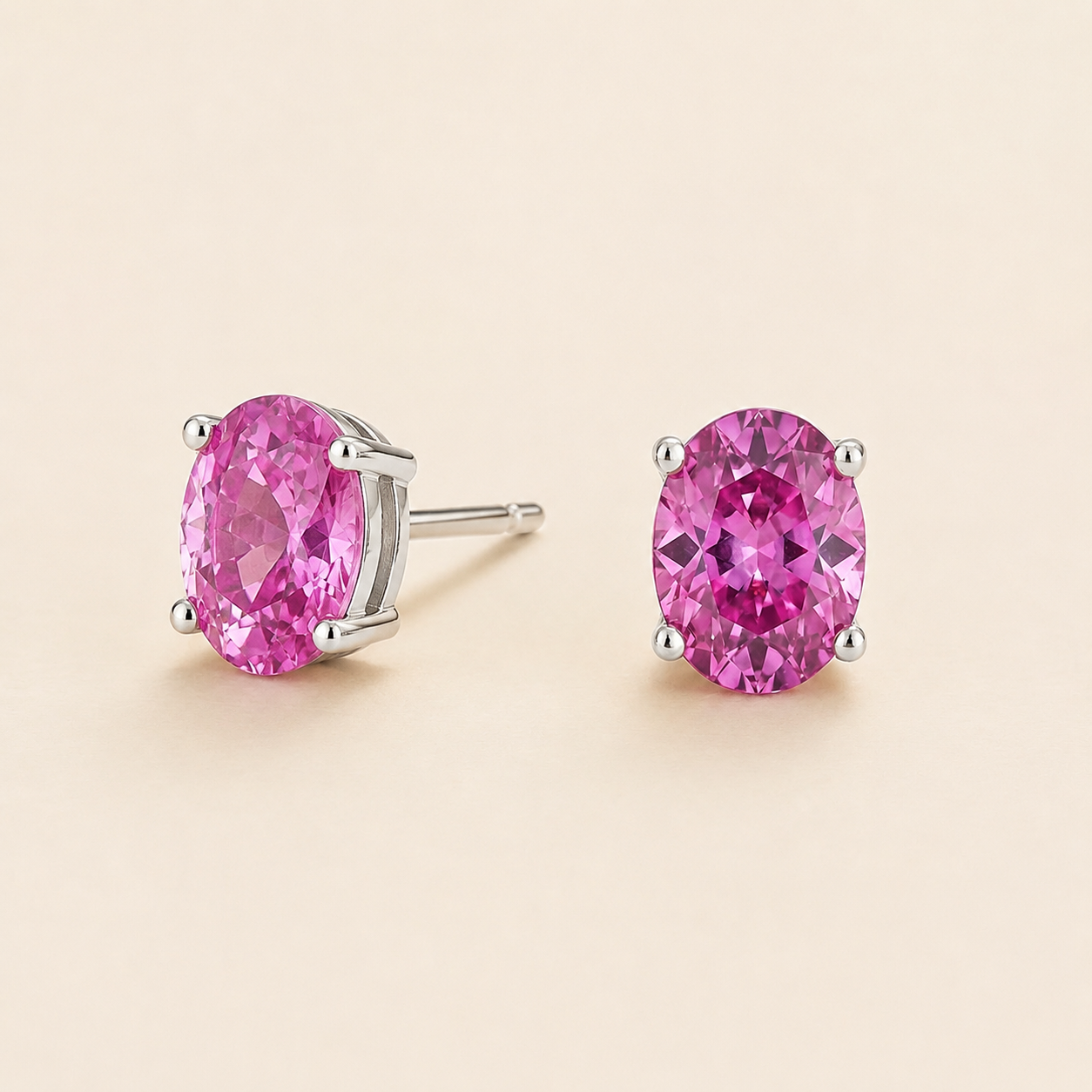 Ovo Vivid Pink Sapphire Oval Solitaire Stud Earrings in White Gold Angle View