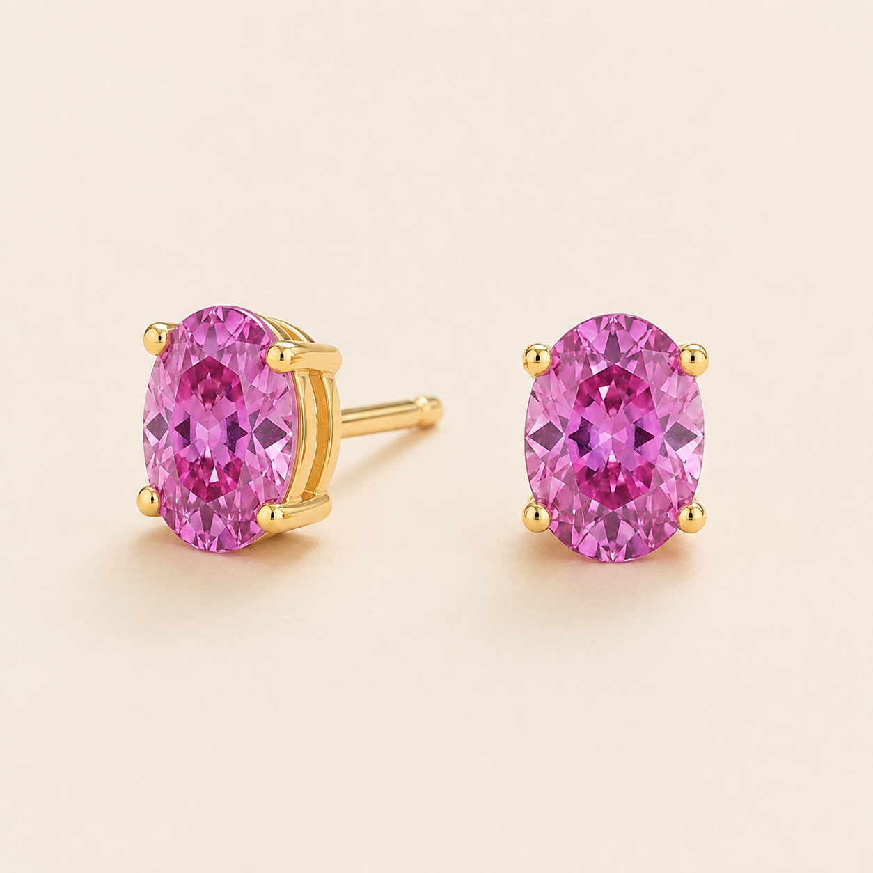 Ovo Vivid Pink Sapphire Oval Solitaire Stud Earrings in Gold Angle View