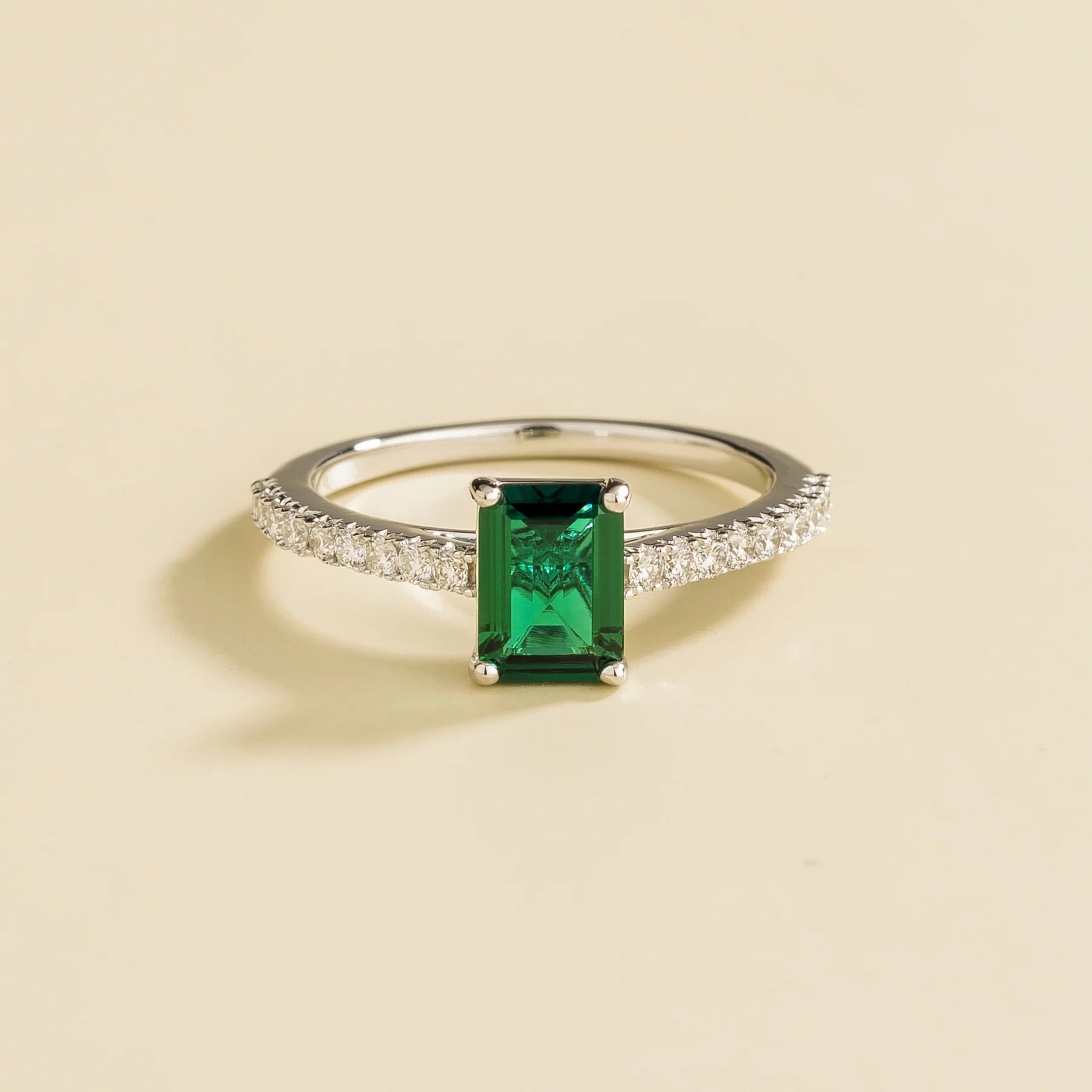 Juvetti white gold fine jewellery ring with lab-grown emerald cut emerald and round lab-grown diamond
