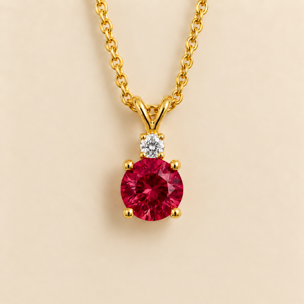 Joie Round Ruby & Diamond Drop Pendant Necklace In Gold by Juvetti London, photographed on a white background