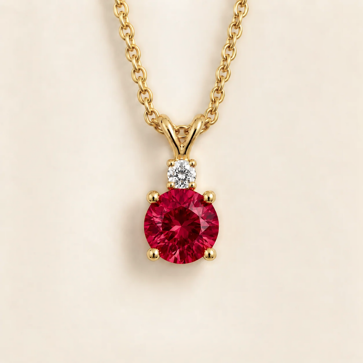 Joie Round Ruby & Diamond Drop Pendant Necklace In Gold by Juvetti London, photographed on a white background