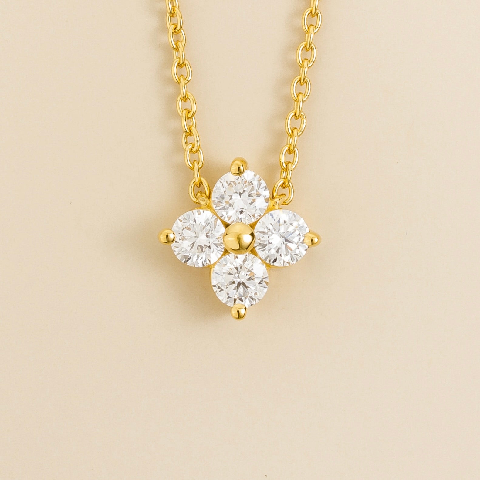 Diamond clover pendant necklace in yellow gold with four round diamonds on a chain