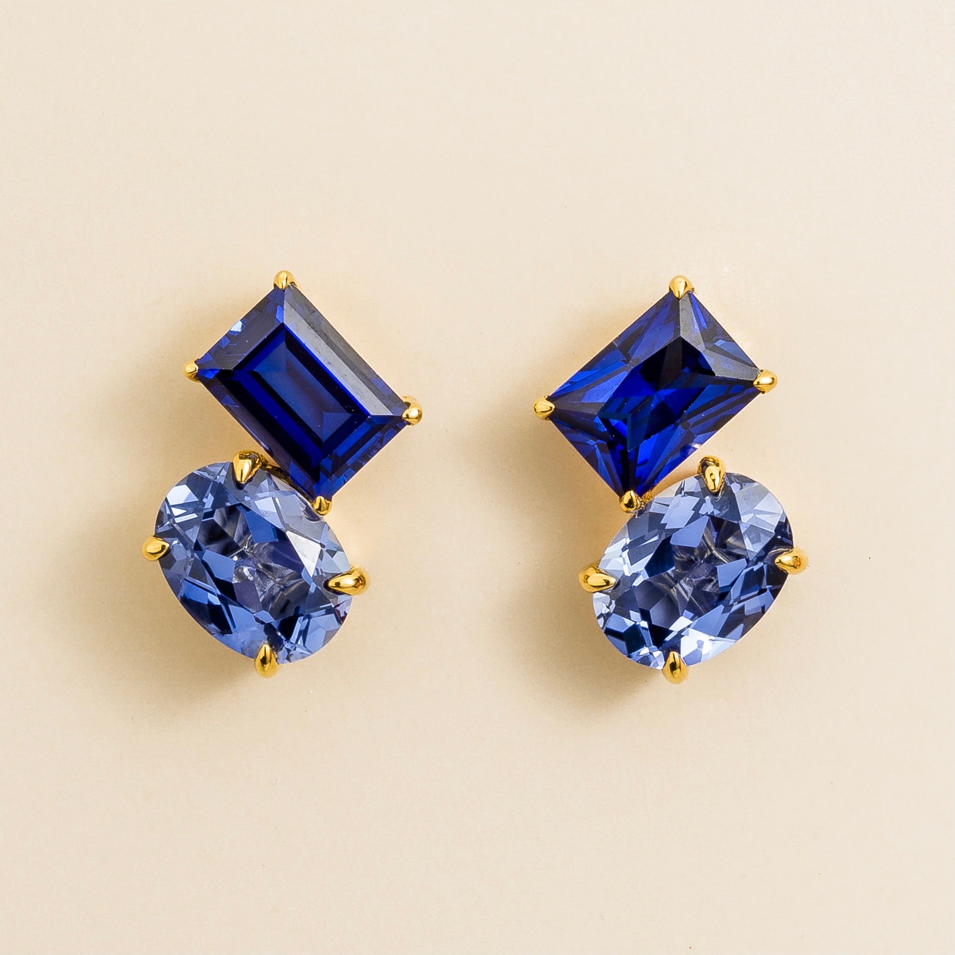 Buchon Toi et Moi gold earrings set with emerald cut royal blue sapphire and oval cut pastel blue sapphire, London jewellery store.