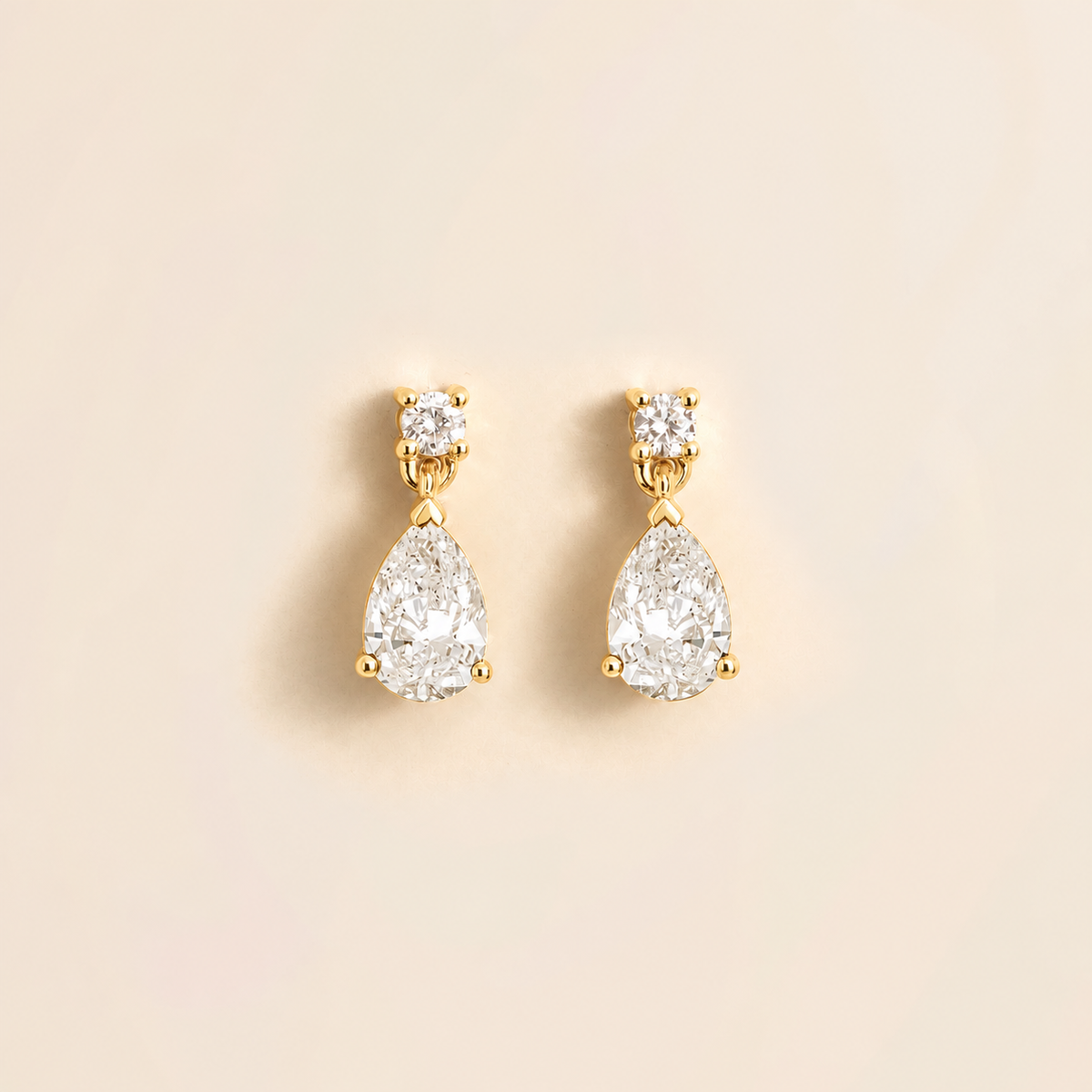 Diamond Pear Drop Earrings in White Gold displayed against a neutral background.
