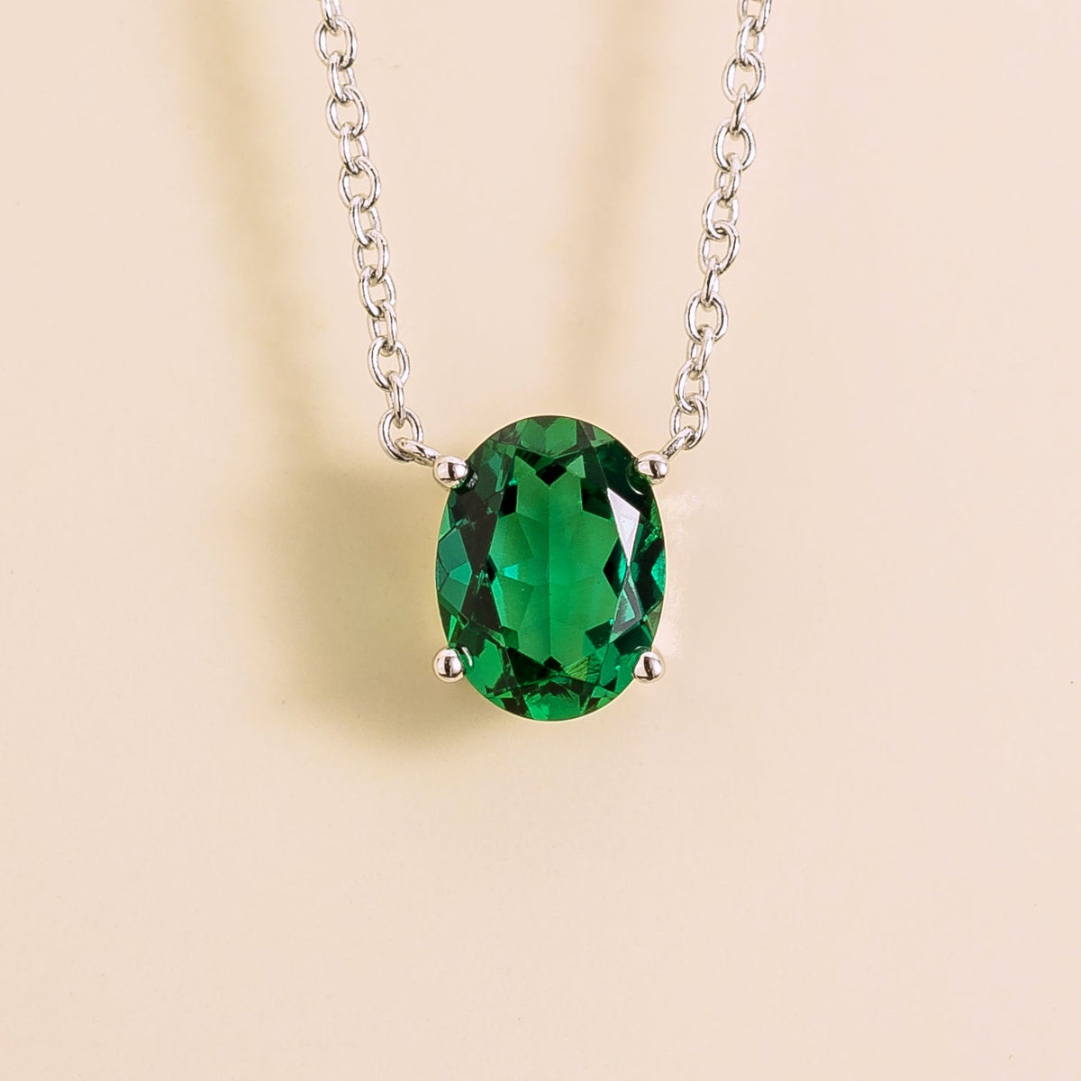 Oval lab-grown emerald solitaire pendant necklace, Ovo design in white gold | Juvetti London
