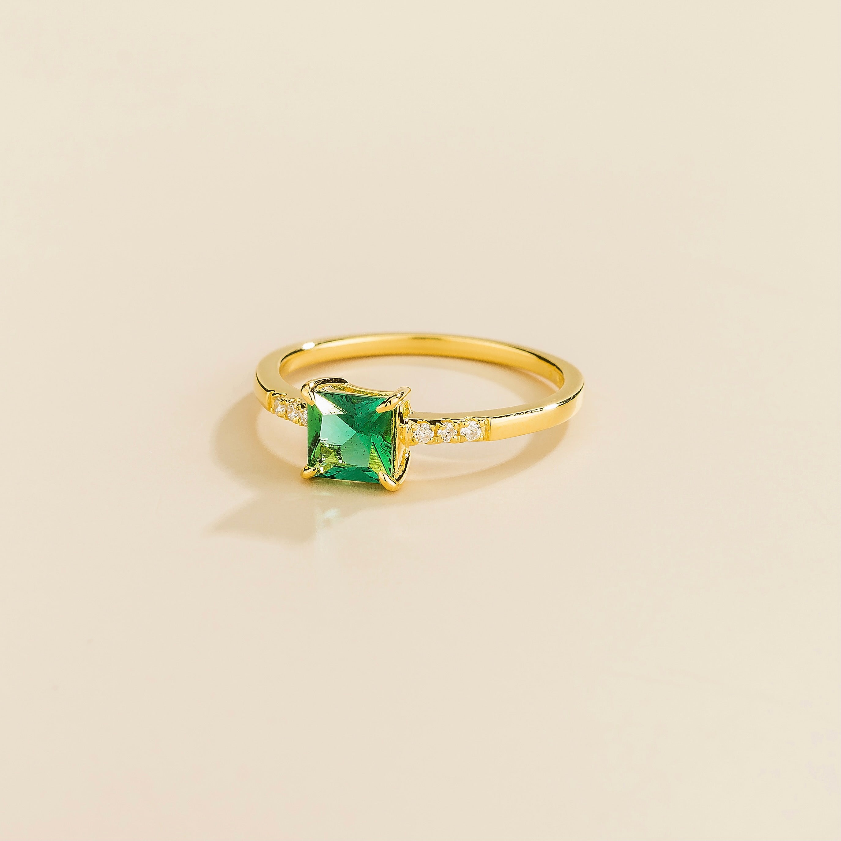 delicate gold ring set with emerald and diamond accents
