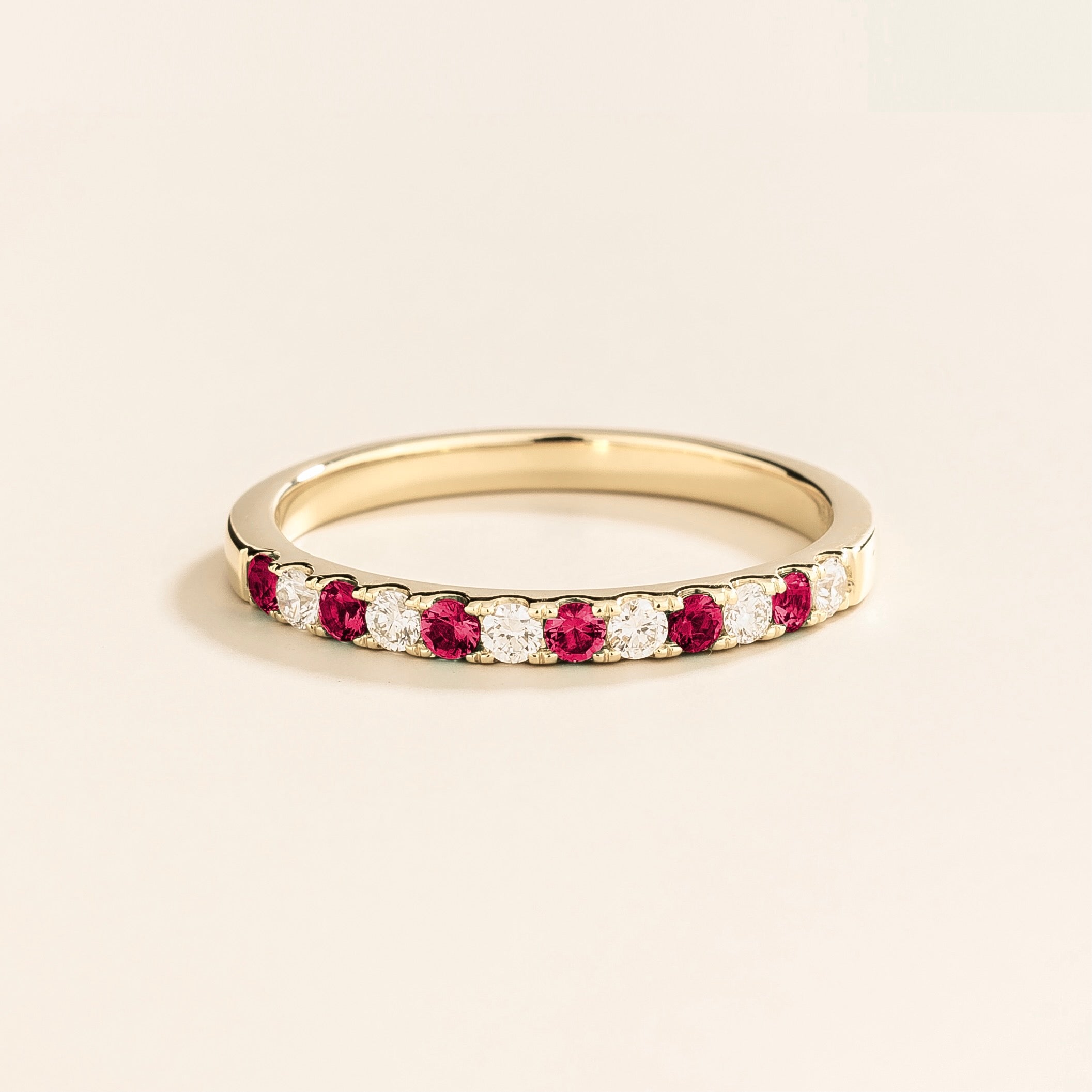 Salto white gold half eternity ring featuring alternating rubies and diamonds along its circumference.