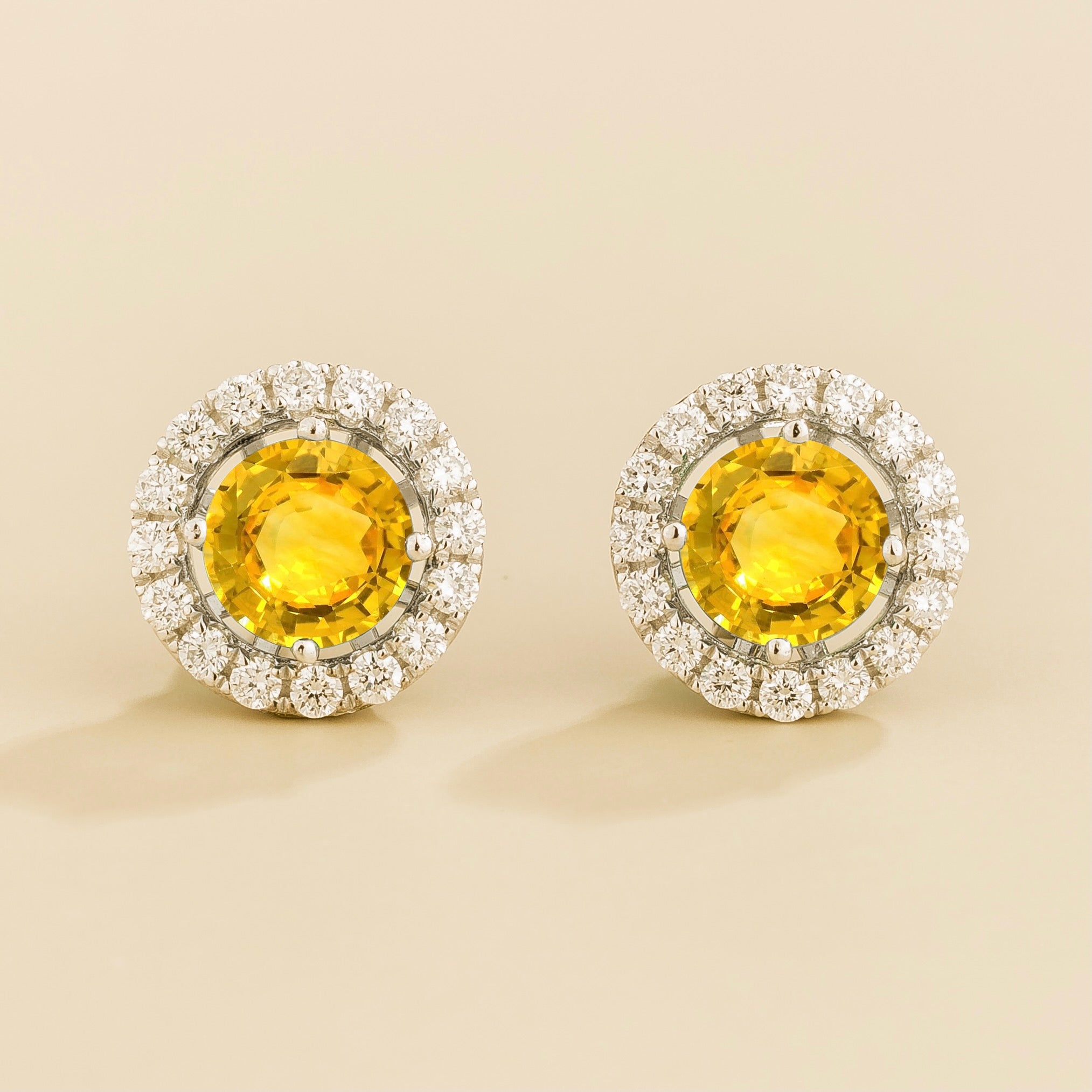 A pair of white gold floret earrings set with round yellow sapphire centerpiece and surrounding round diamonds halo. Removable halo piece. – Juvetti London