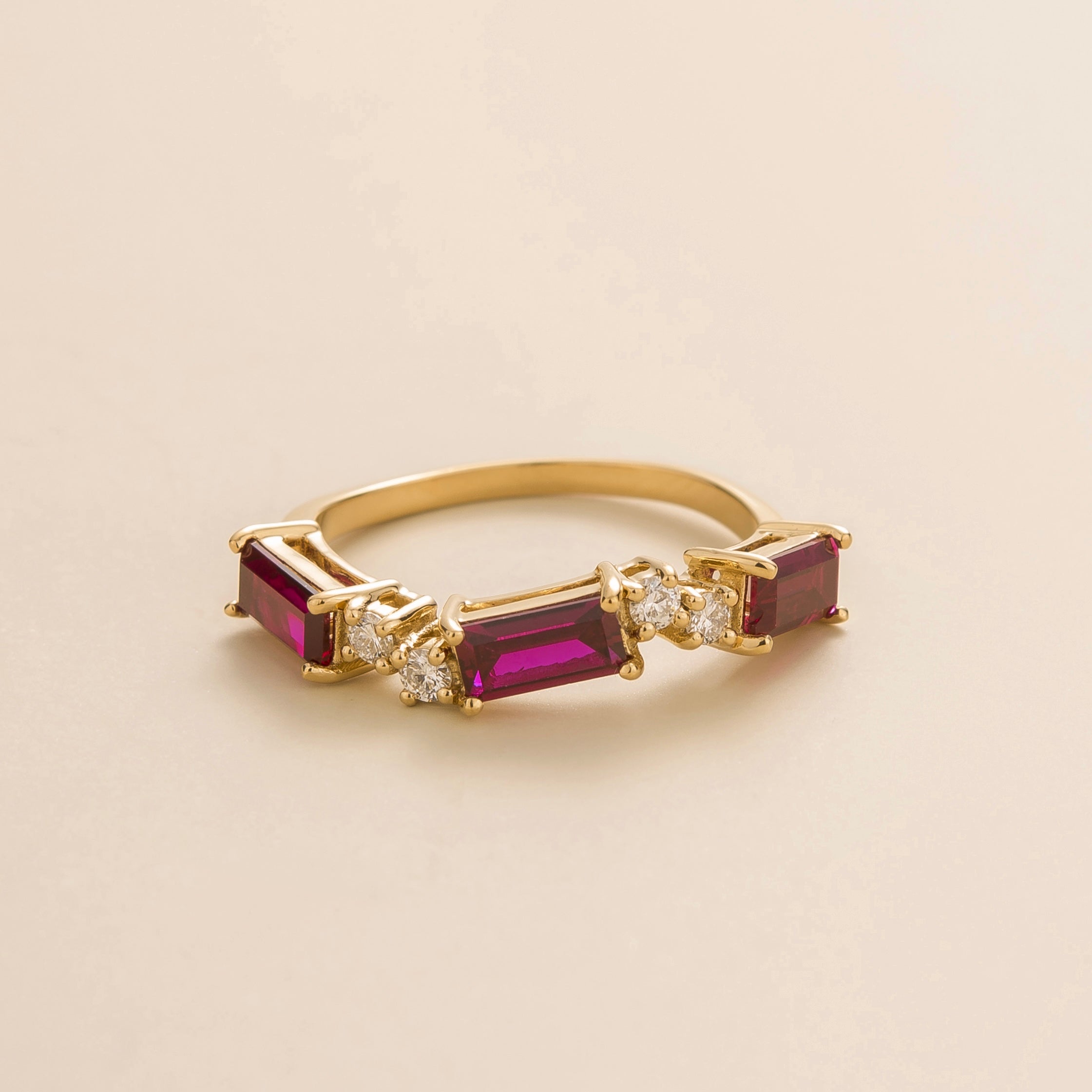 Juvetti gold ring showcasing ethical lab-grown baguette-cut ruby and round brilliant diamonds.