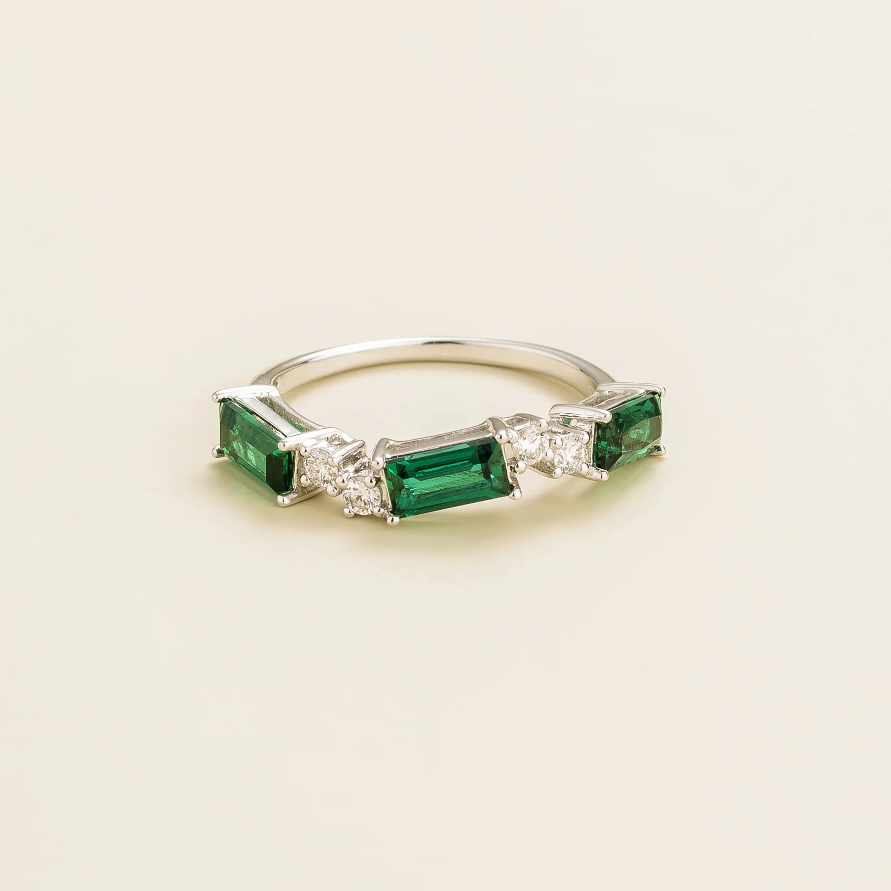 Juvetti white gold ring showcasing ethical lab-grown baguette-cut emeralds and round brilliant diamonds.