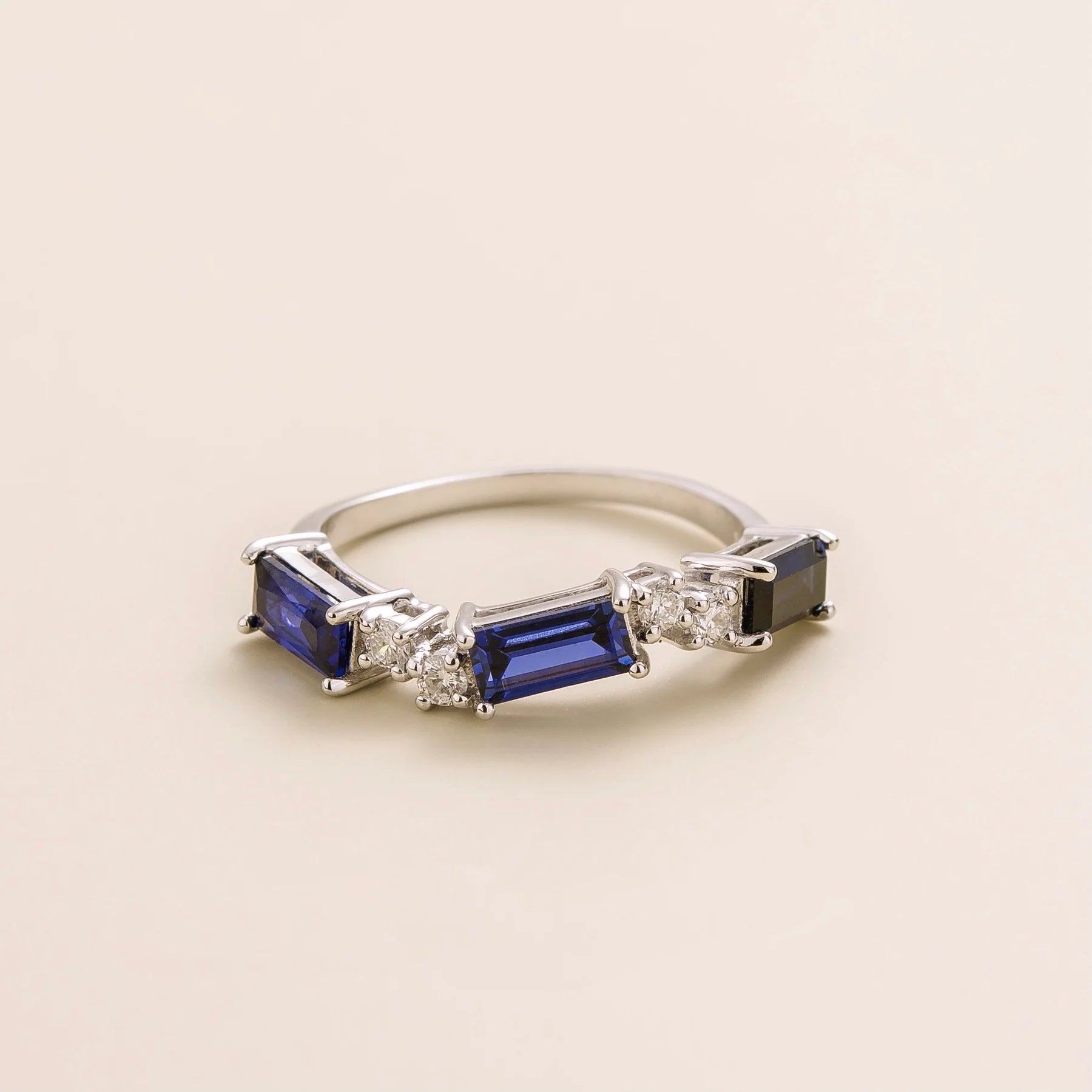 Juvetti white gold ring showcasing ethical lab-grown baguette-cut royal blue sapphires and round brilliant diamonds.