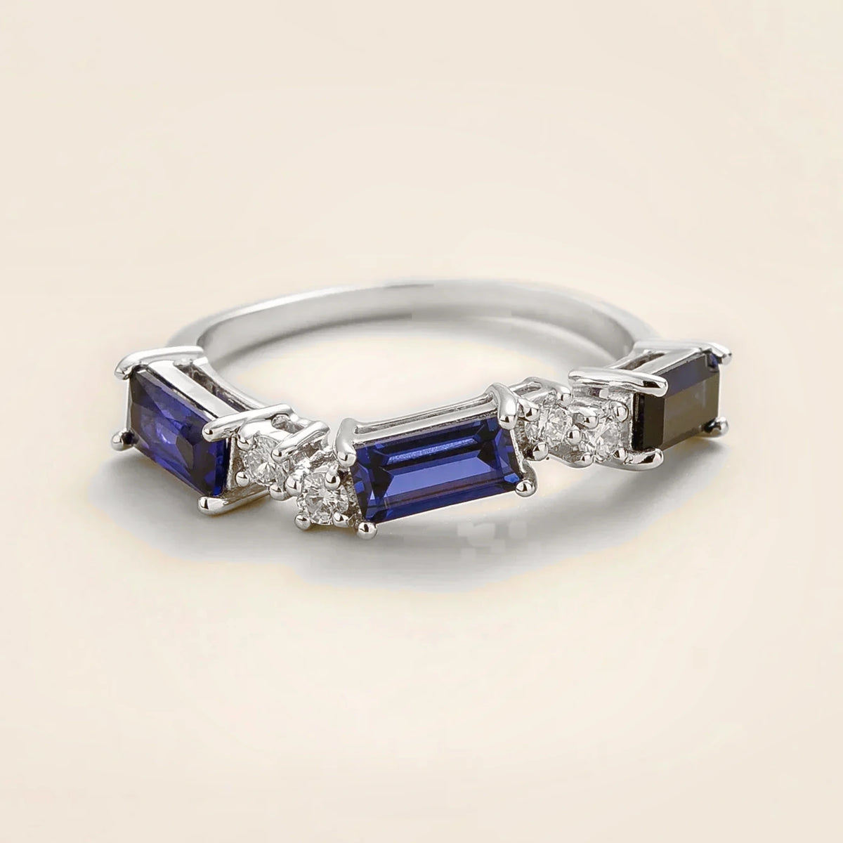 Juvetti white gold ring showcasing ethical lab-grown baguette-cut royal blue sapphires and round brilliant diamonds.