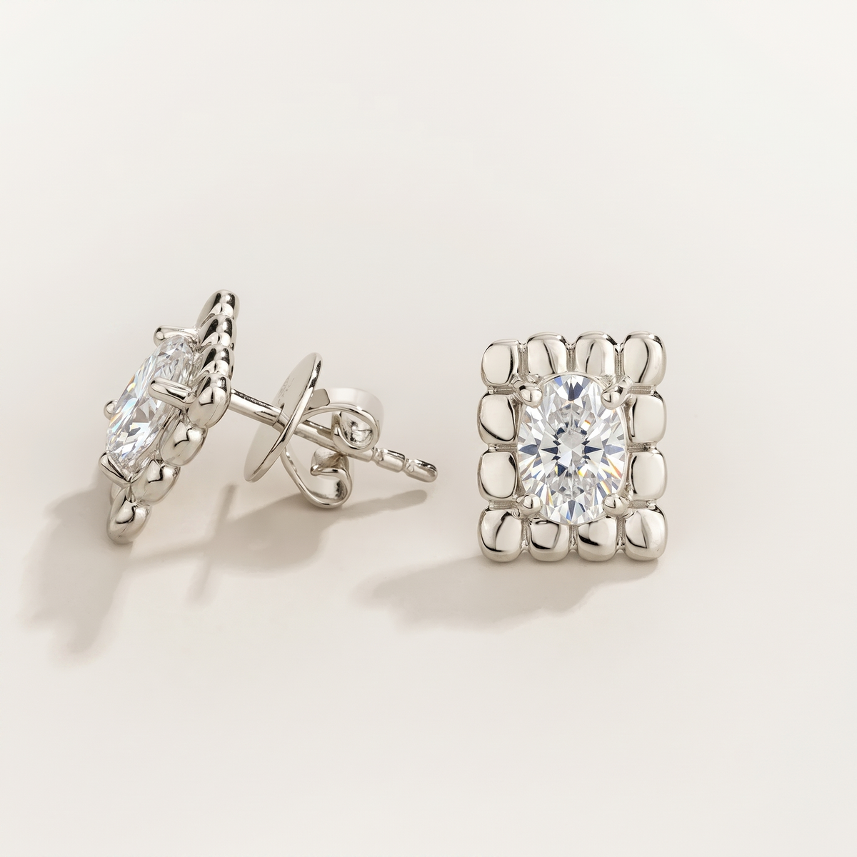 Fondi Oval Diamond Sculpted White Gold Stud Earrings – angle view