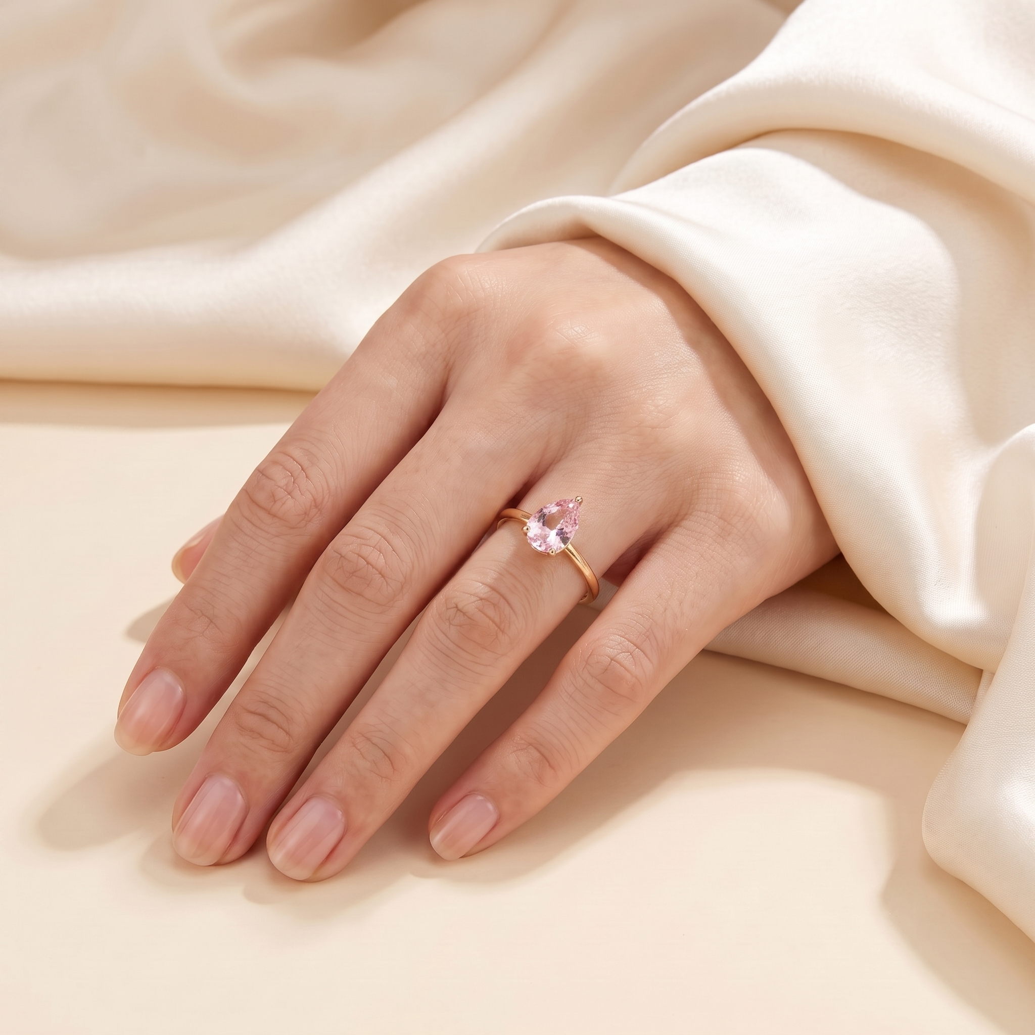 A model is wearing Pandal Pear Shape Pastel Pink Sapphire Cathedral Solitaire