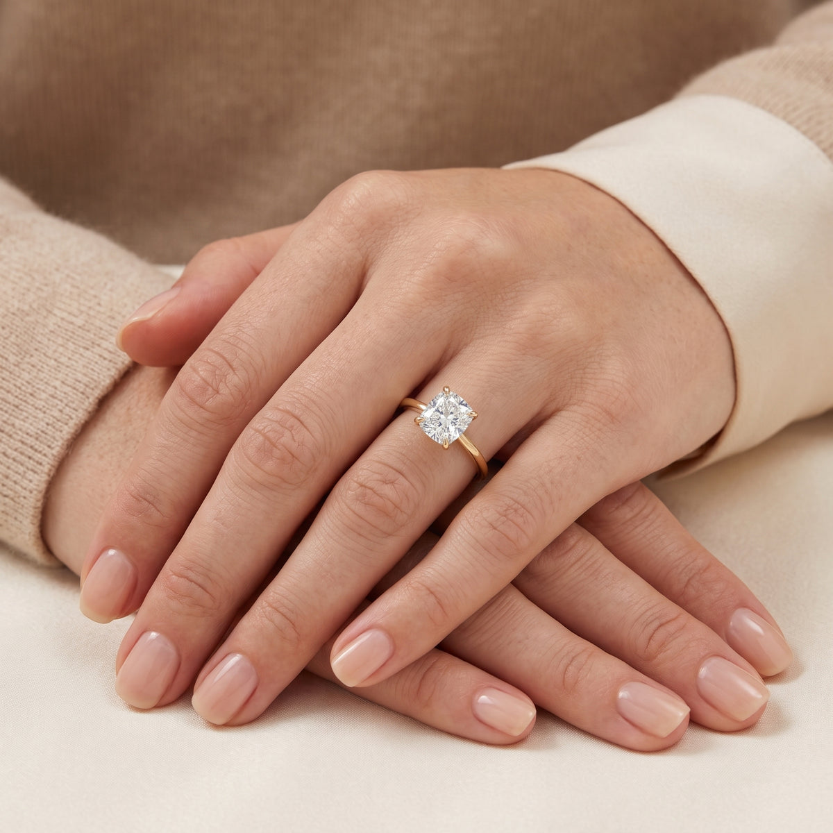 The model is wearing Iris Cushion Shape Diamond Cathedral Solitaire Ring in Gold