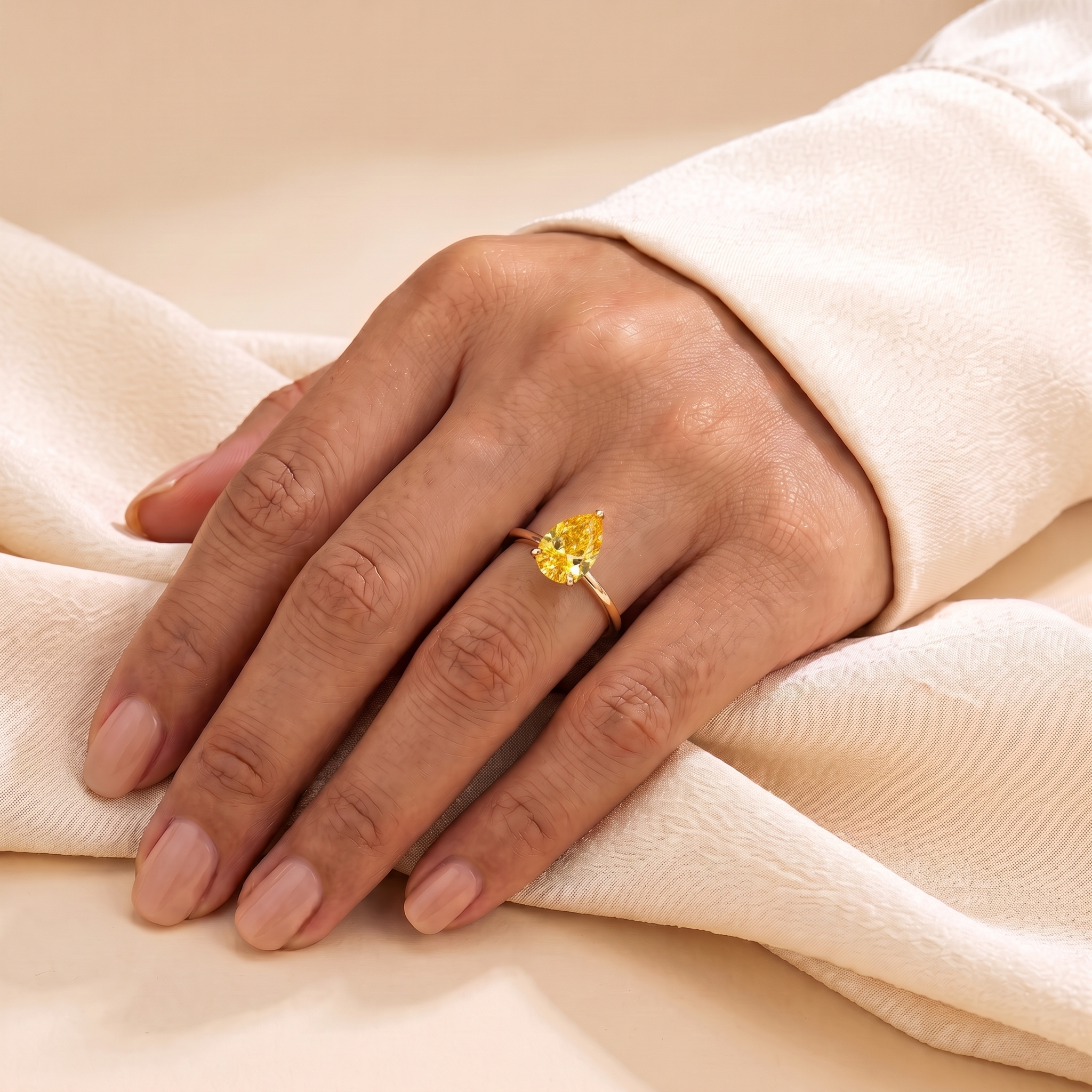 A model is wearing Pandal Pear Shape Yellow Sapphire Cathedral Solitaire