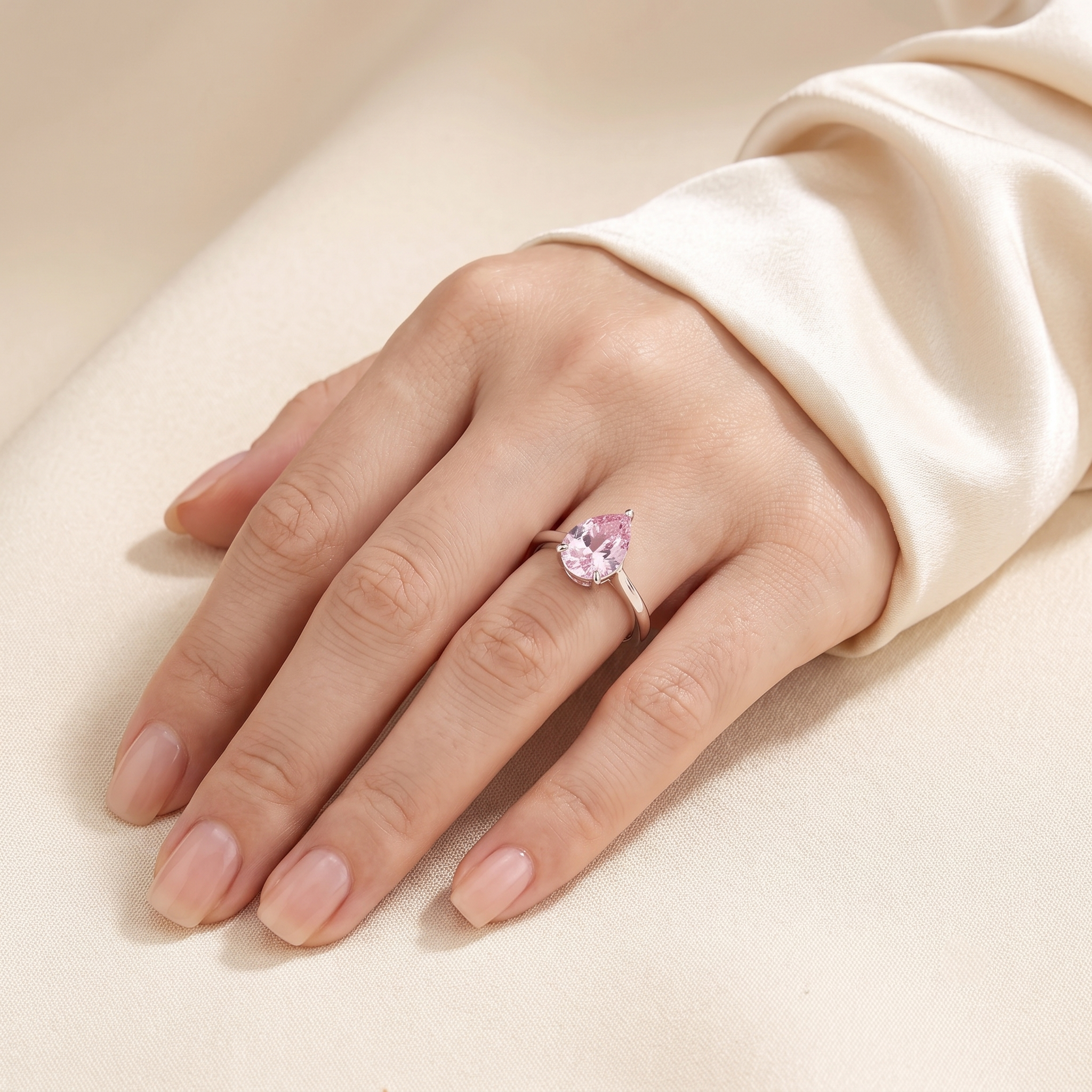 A model is wearing Pandal Pear Shape Pastel Pink Sapphire Cathedral Solitaire Ring in White gold