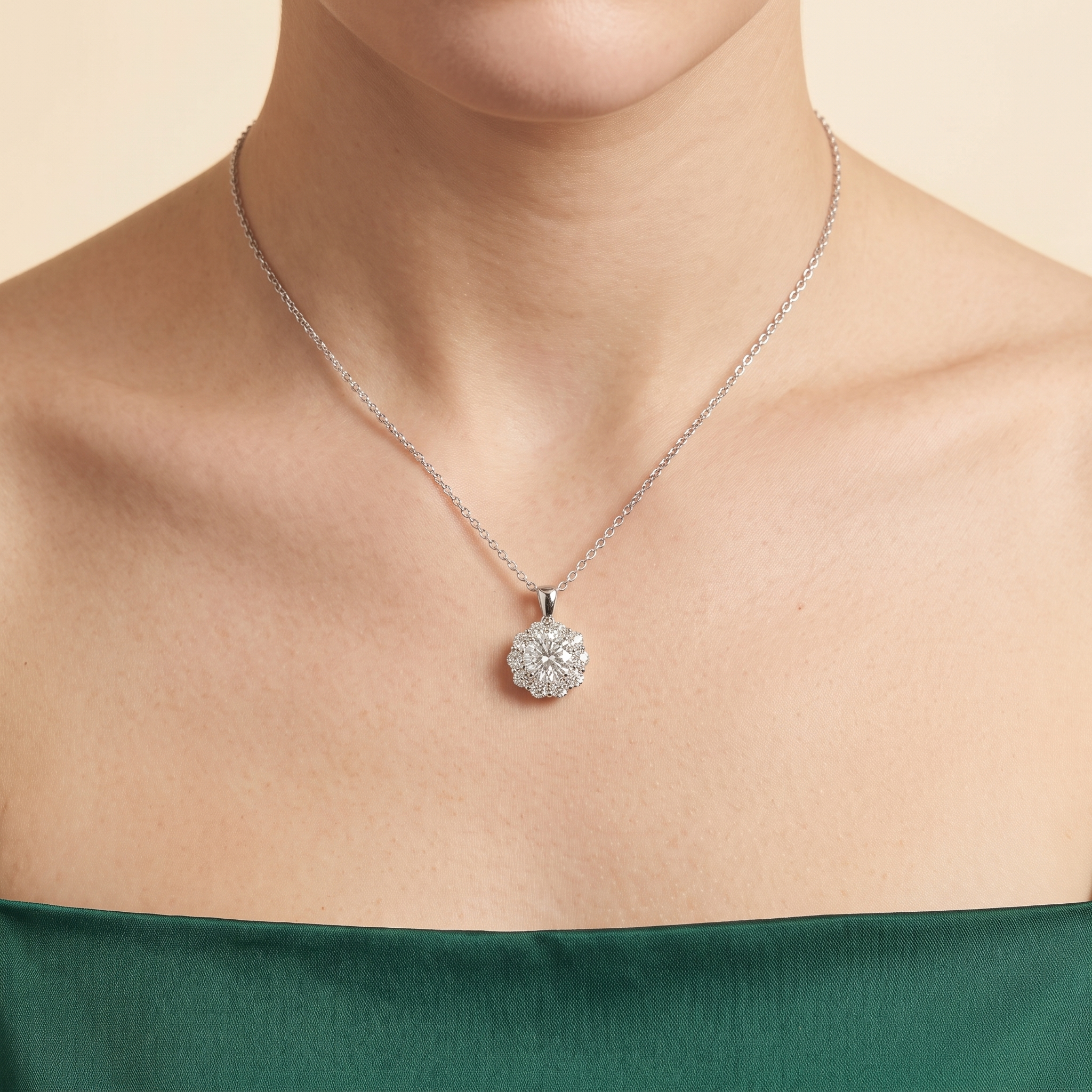 A model is wearing Floret Diamond Halo Pendant Necklace in White Gold by Juvetti, bespoke jewellery London