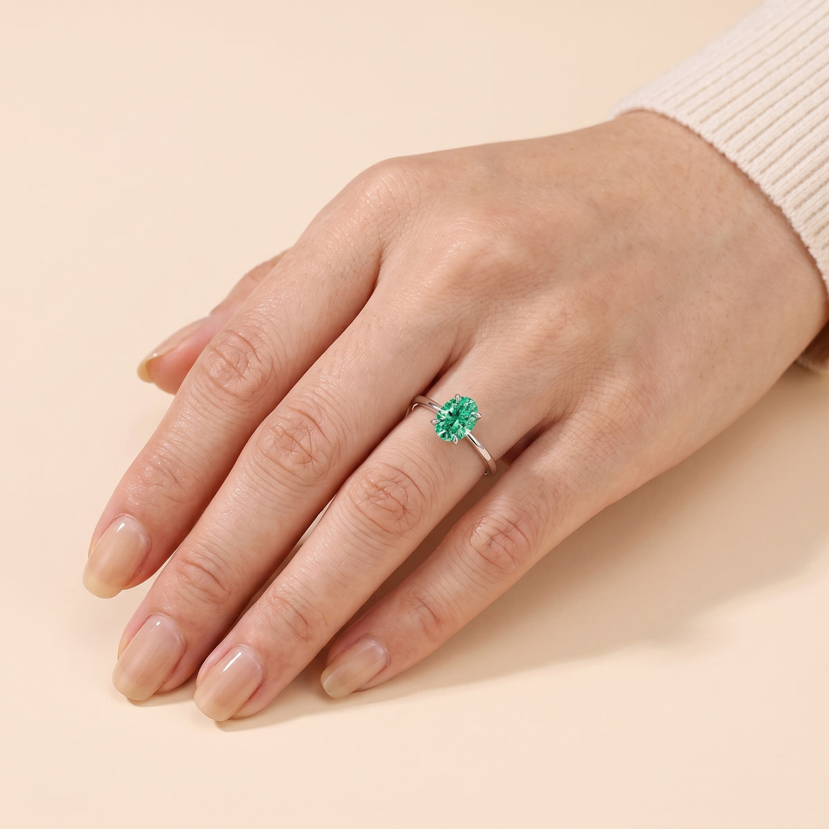 The model is wearing Lyra Oval Shape Green Sapphire Cathedral Solitaire Ring in White Gold