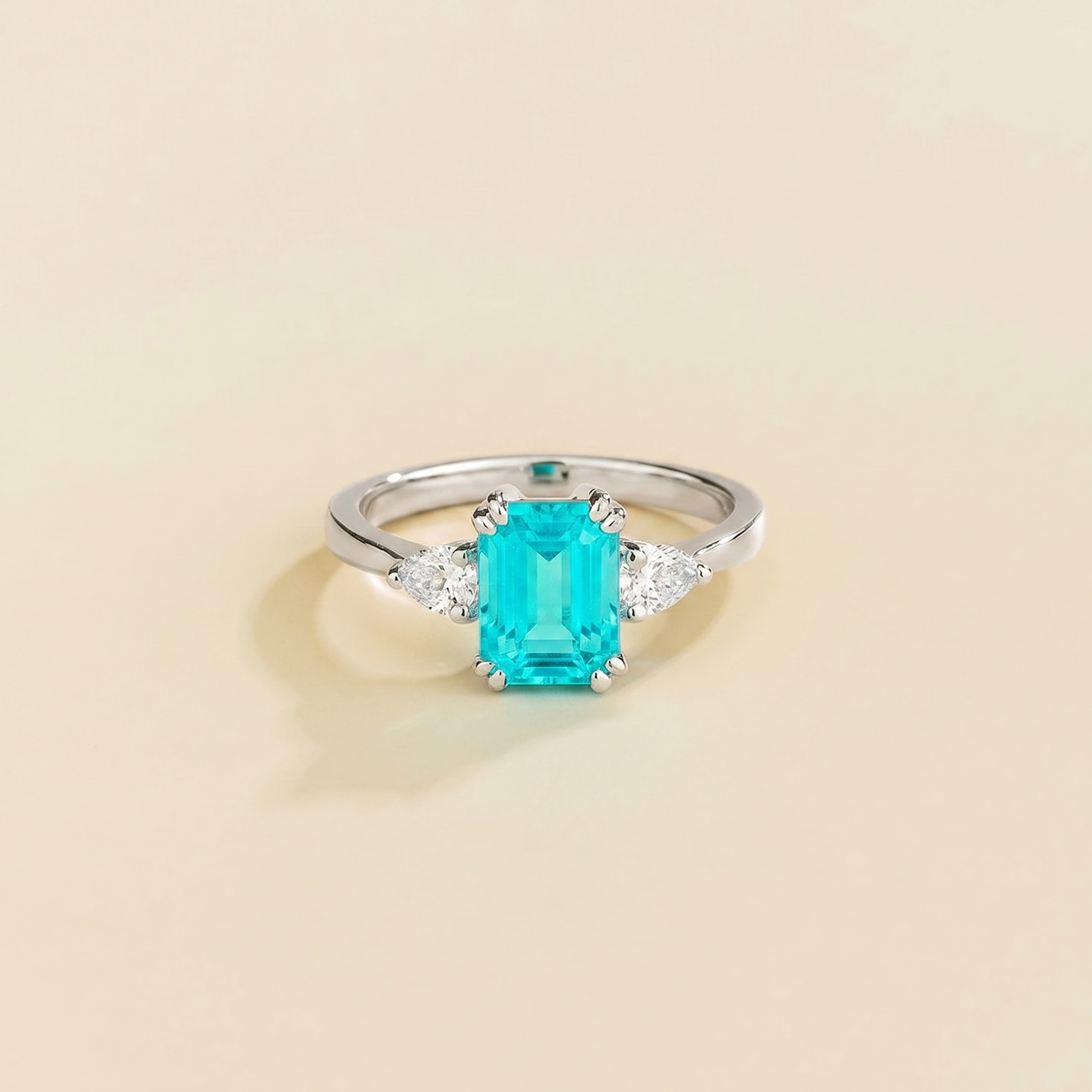 Ailes ring in 18K white gold vermeil set with lab grown diamond and emerald-cut Paraiba tourmaline gem stones. Juvetti Bespoke Jewellery London