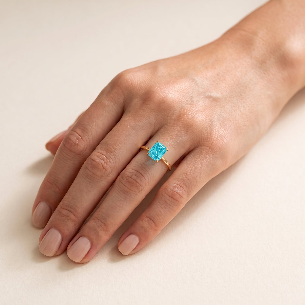A model is wearing Clair Radiant Shape Paraiba Cathedral Solitaire Ring