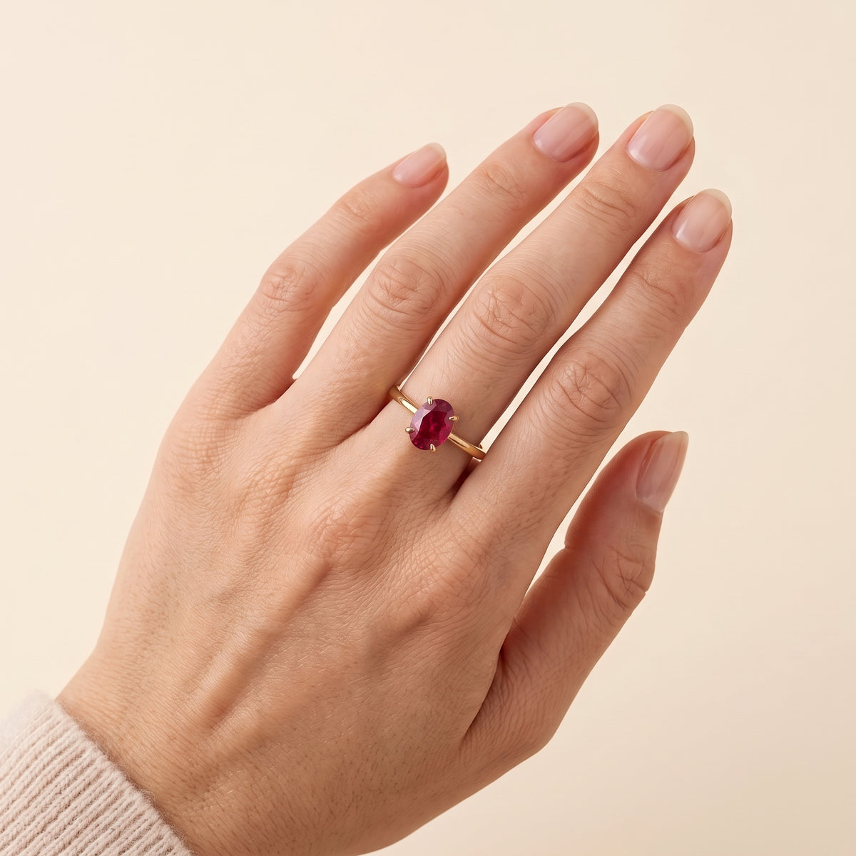 A model is wearing Lyra Oval Shape Ruby Cathedral Solitaire Ring in Gold