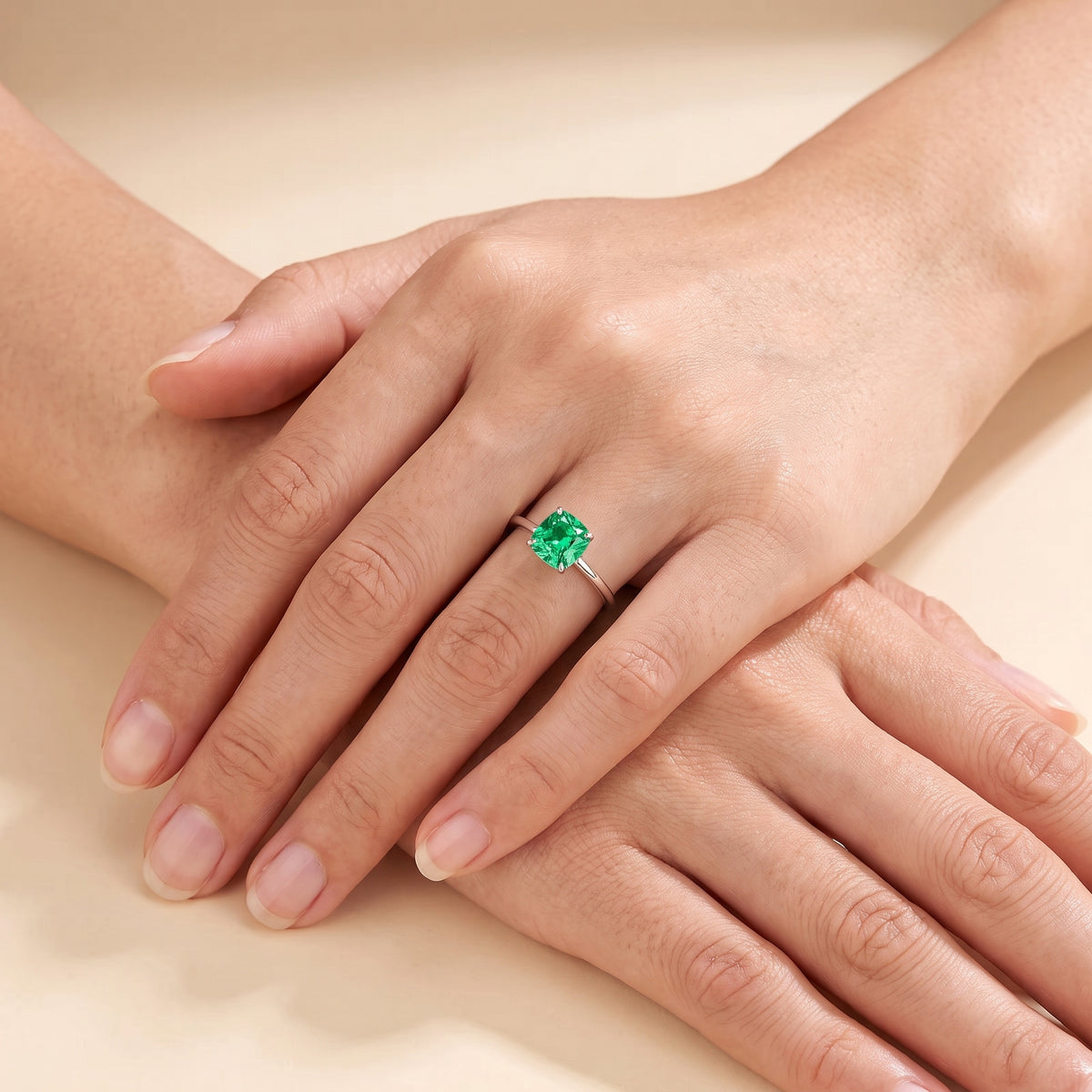 A model is wearing Iris Cushion Shape Green Sapphire Cathedral Solitaire