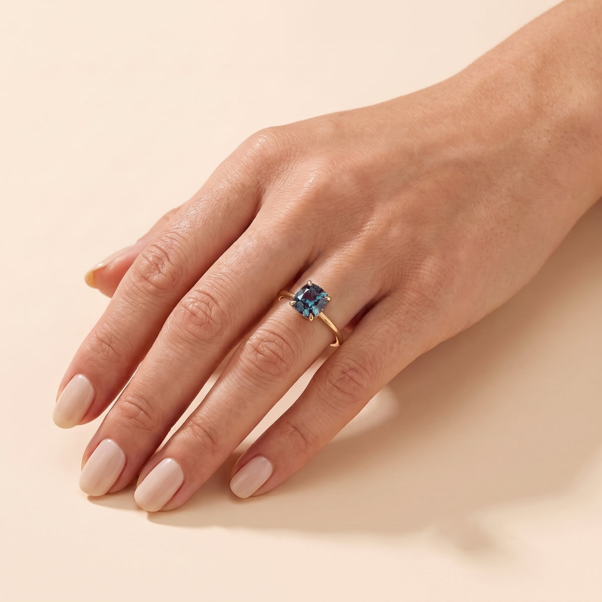 A model is wearing Iris Cushion Shape Alexandrite Cathedral Solitaire