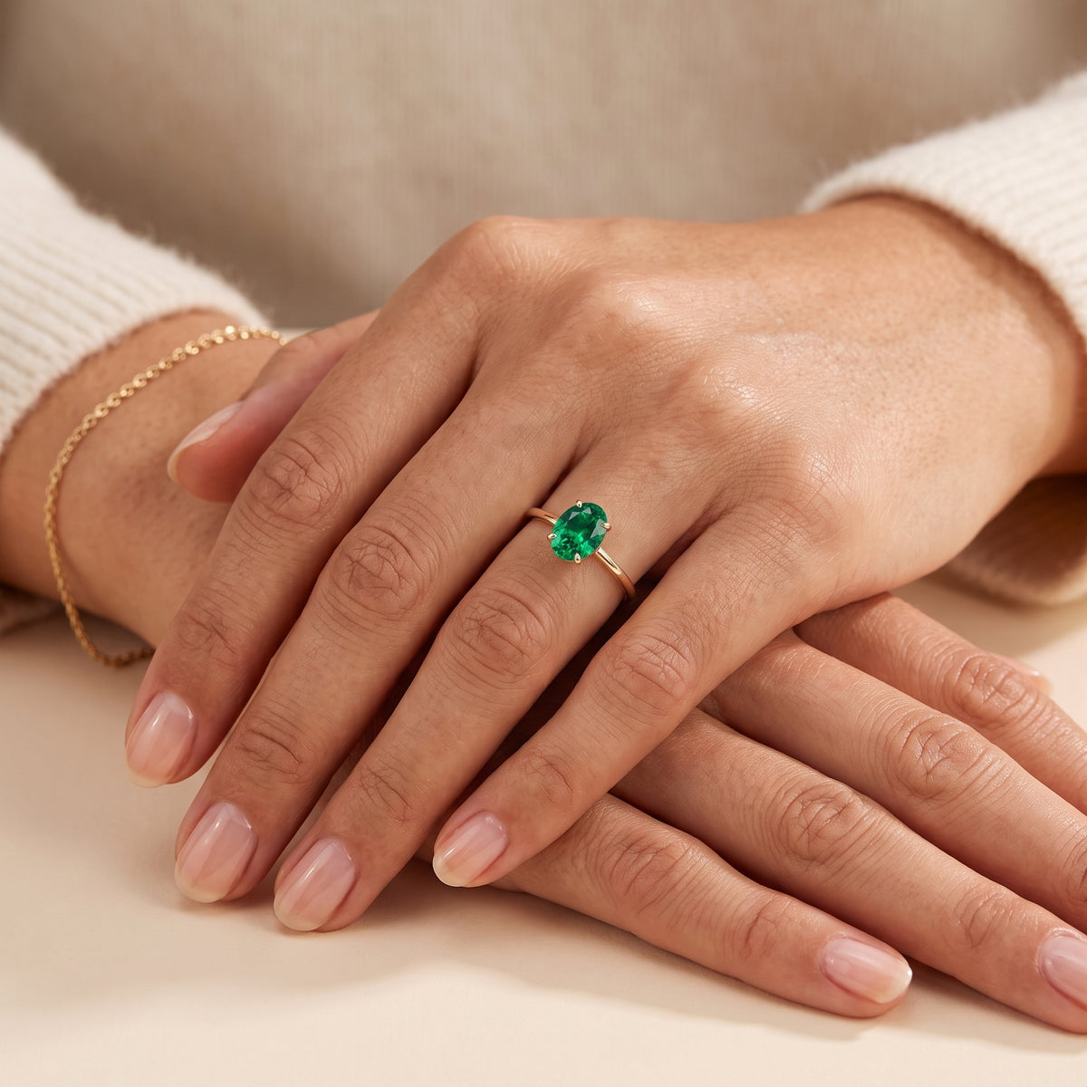 The model is wearing Lyra Oval Shape Emerald Cathedral Solitaire Ring in Gold